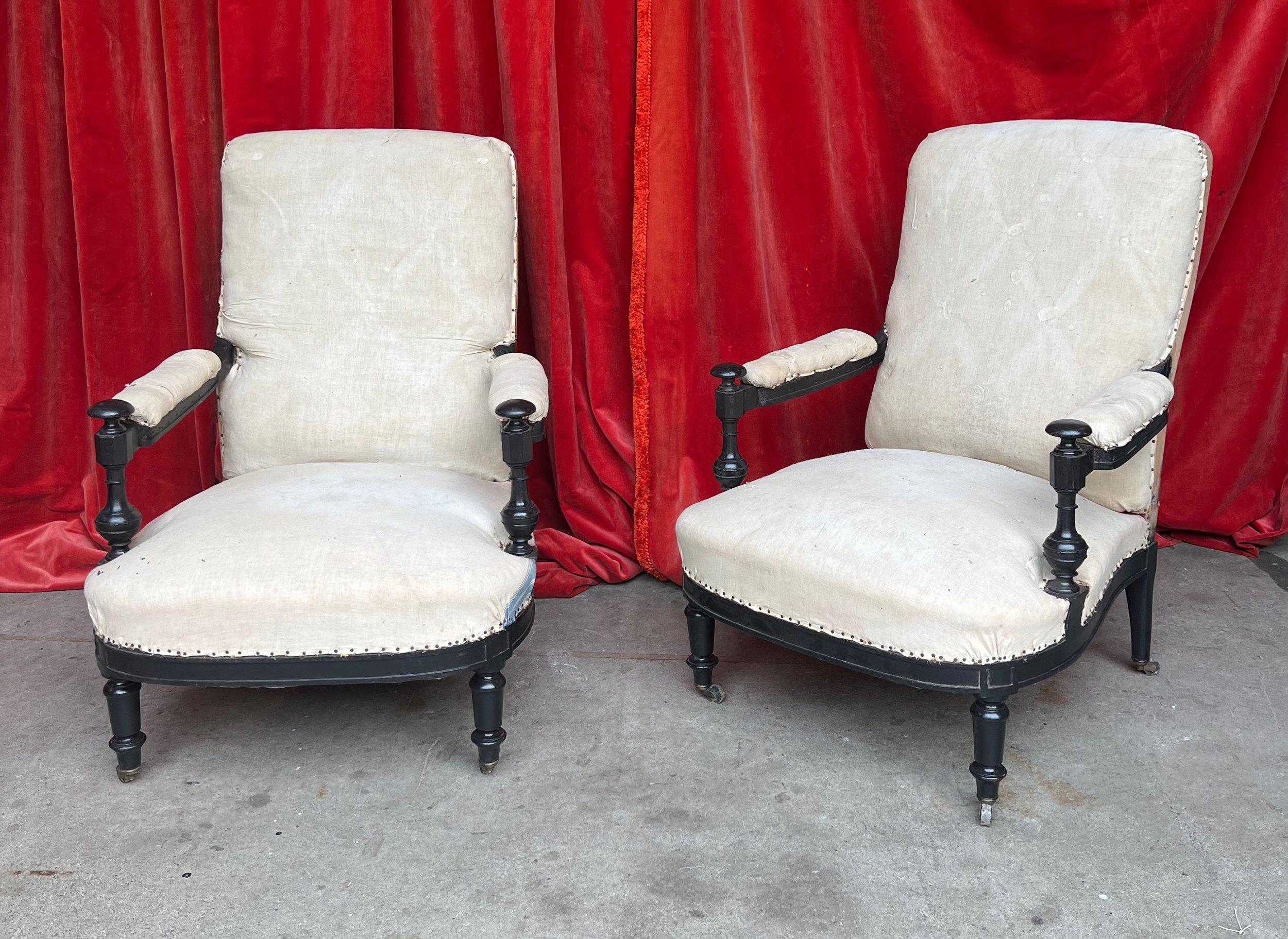 An extraordinary pair of French Napoleon III armchairs, featuring exposed wooden arms and classic turned legs. These 19th-century chairs captivate with their beautiful wooden spindle arm details, adding sophistication and elegance to any living