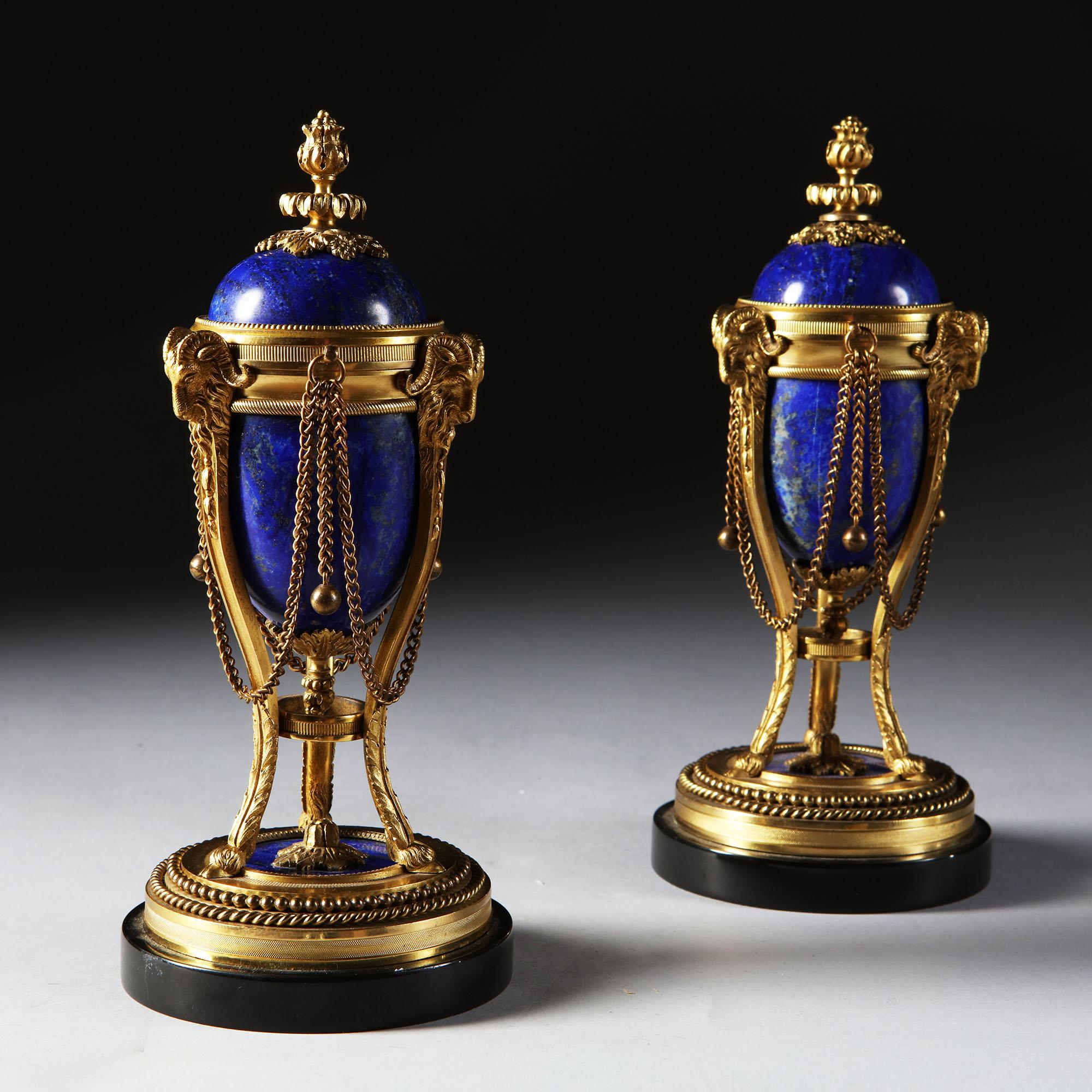 So rare to find such a beautiful pair of lapis lazuli mounted ormolu cassolettes. The lapis on these is almost pure blue, perfect contrast against the gold of the ormolu. 

These are 19th century from the Napoleon III period, they are based on a
