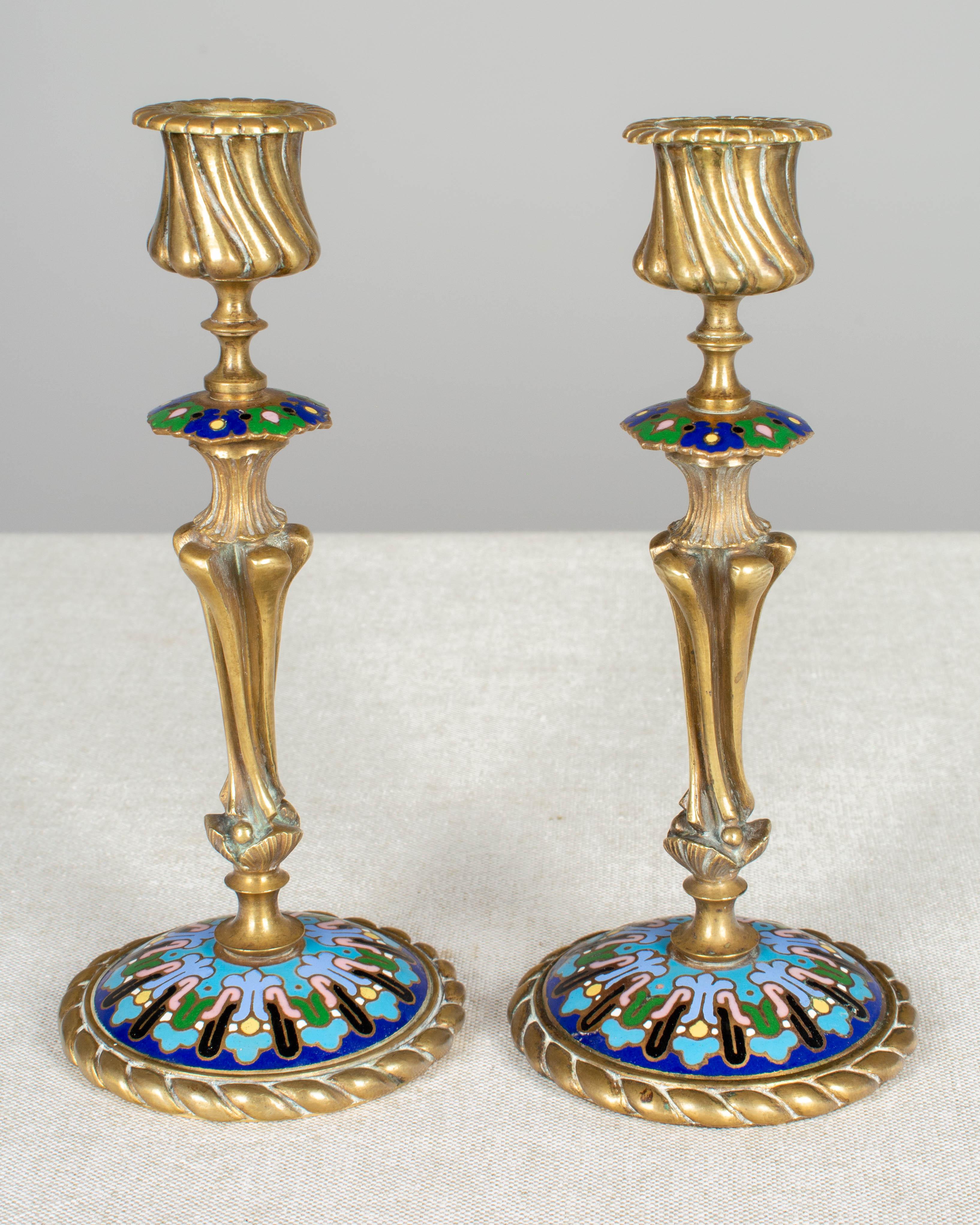 A pair of French Napoleon III brass cloisonné enamel candlesticks. Maker's mark on underside. Please refer to photos for more details. We have a large selection of French antiques at Olivier Fleury, Inc.