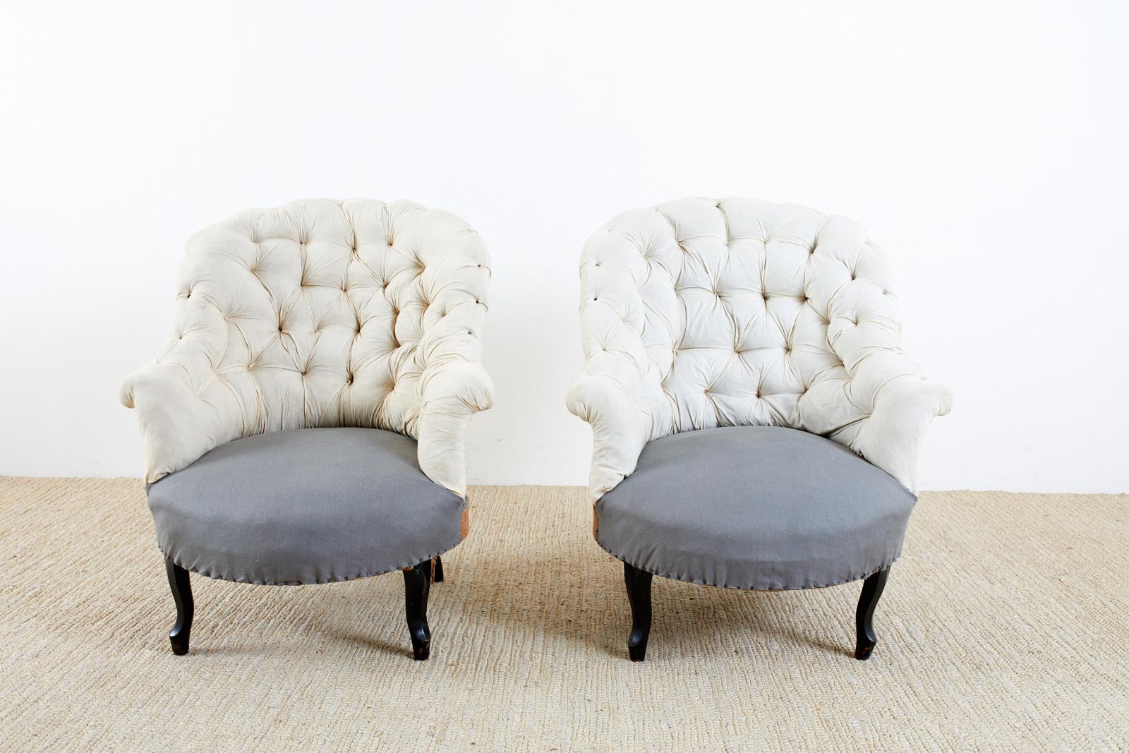 Charming pair of 19th century French Napoleon III period slipper chairs having a deconstructed style. The chairs feature a curved back with a tufted padding of muslin and an exposed back side of hand tied burlap. The round seat is upholstered with