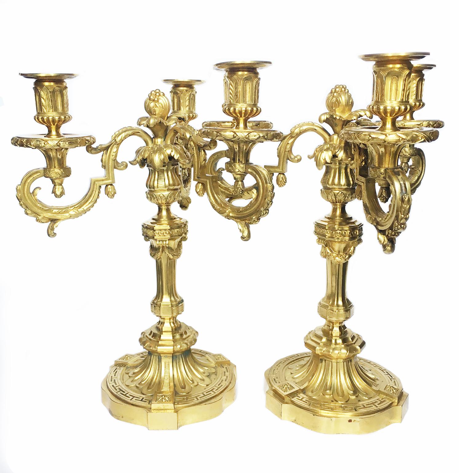 Pair of three-flame candelabra
Cast bronze, chiselled and mercury gilded 
France, third quarter of the nineteenth century
Height 14.96 in (38 cm) X 12.59 (32 cm)
Weight 11.46 lb (5.2 kg) each
State of conservation: very good

The two