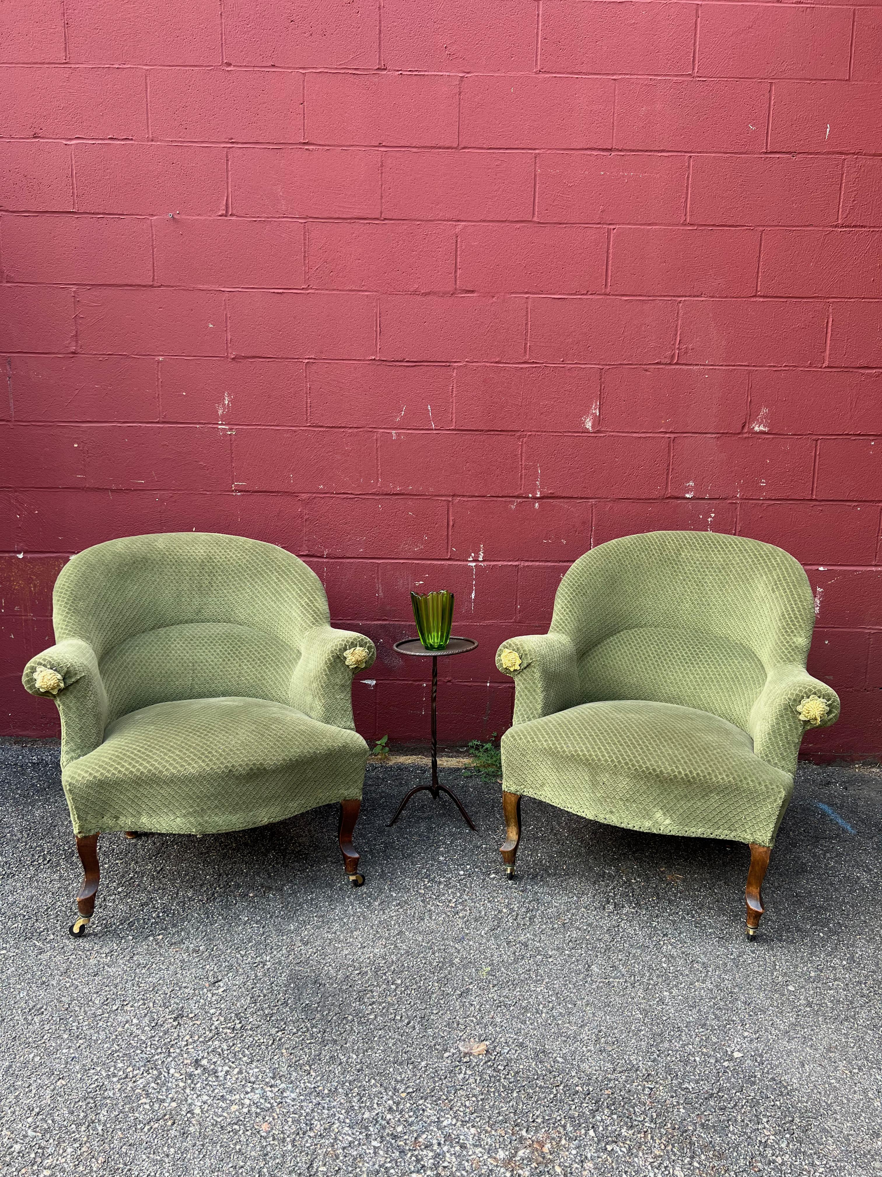 A classic pair of Napoleon III-style armchairs. Crafted in the late 19th century, these elegant chairs feature cabriole legs with added casters on the front legs to provide a beautiful pitch while making it easy to move the chairs around a room. The