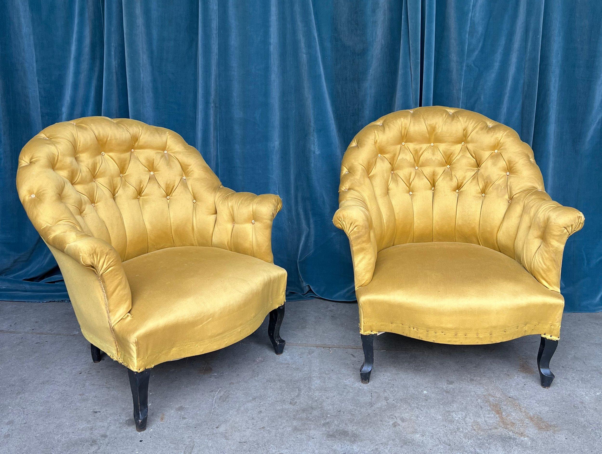 A handsome pair of French Napoleon III armchairs from the late 19th century, offering both comfort and style in abundance. Upholstered in a stunning vintage gold fabric, these chairs exude a stately presence that blends seamlessly with traditional