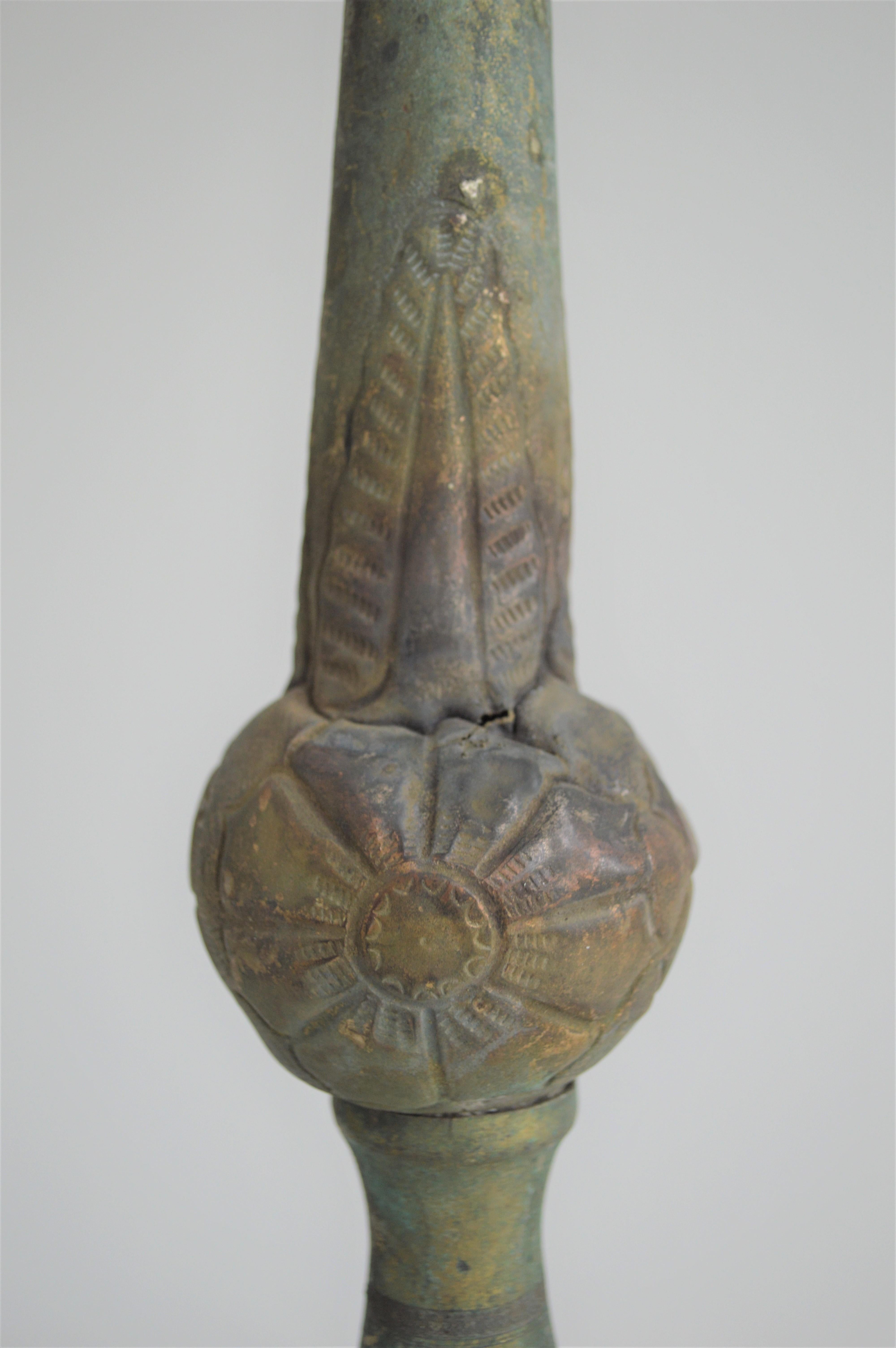 Pair of patinated bronze church candelabras, tripod with a flower motive on the middle.