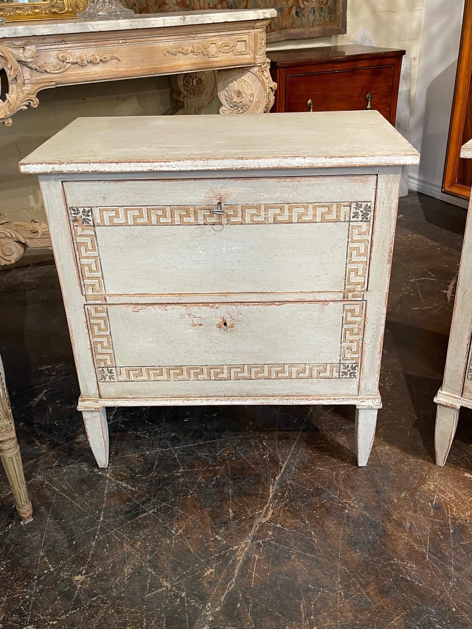 Handsome pair of French Neo-Classical bed side chest with painted Greek Key design. Beautiful patina of a pale grey, gold and black. Creates a beautiful decorative touch!