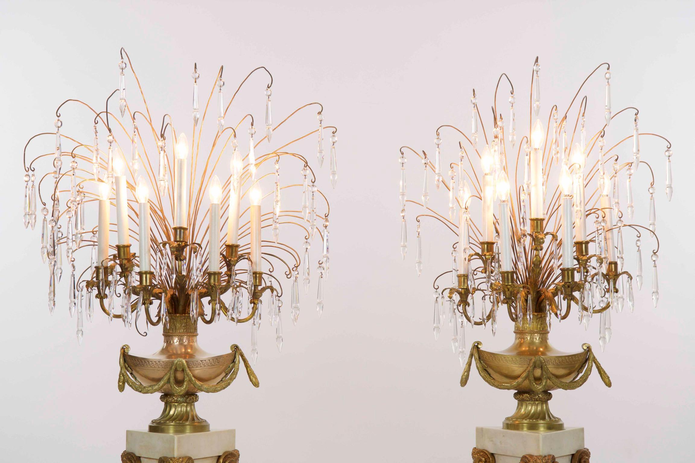 Pair of neoclassical white marble and gilt bronze candelabra likely, French, circa early 20th century

This unusually excellent pair of seven-light candelabra are a powerful strike point for the interior, each with a series of crystals hanging