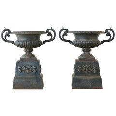 Pair of French Neoclassical Cast Iron Urns on Pedestals