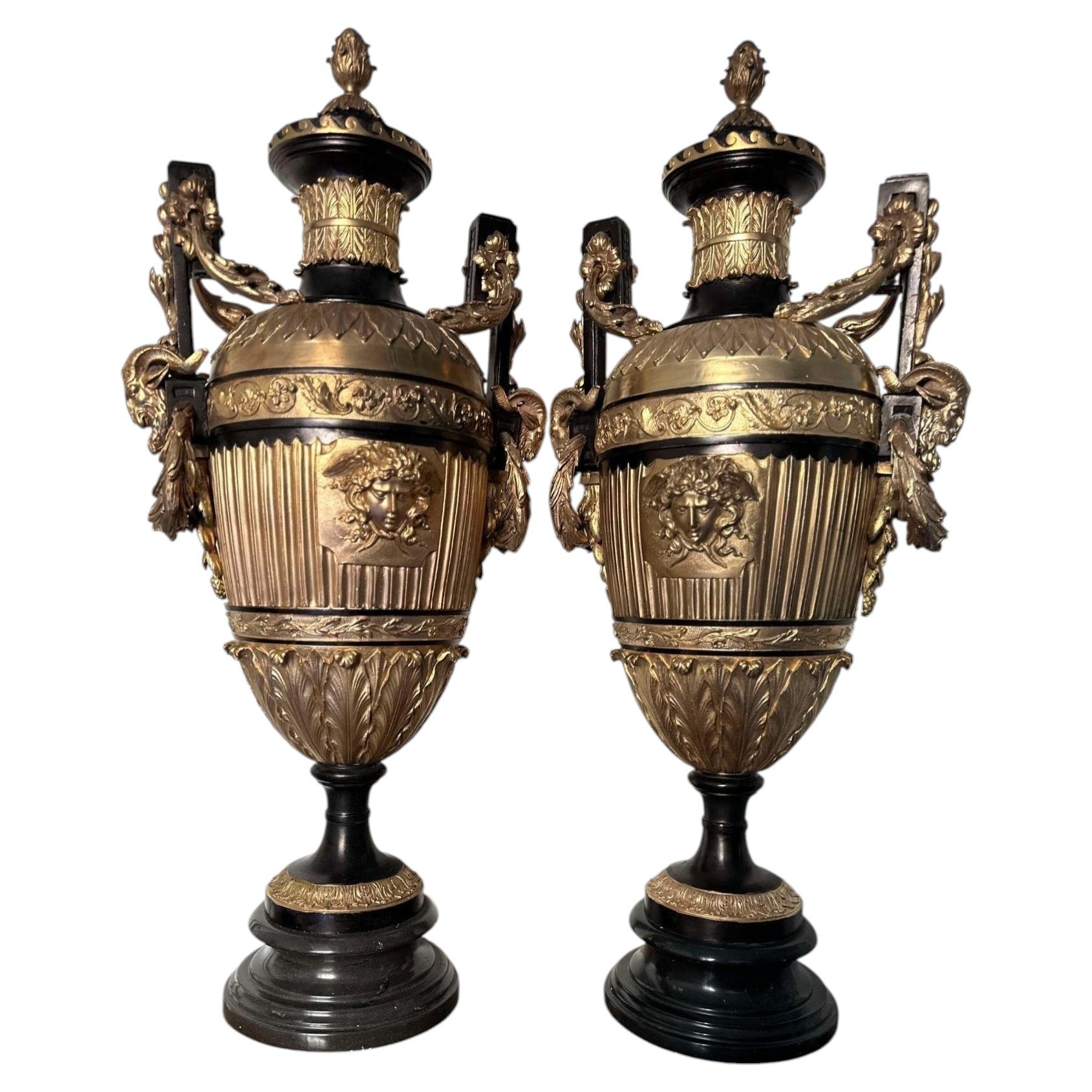 Coppia di urne neoclassiche francesi in bronzo dorato e marmo nero con decorazioni raffiguranti Medusa