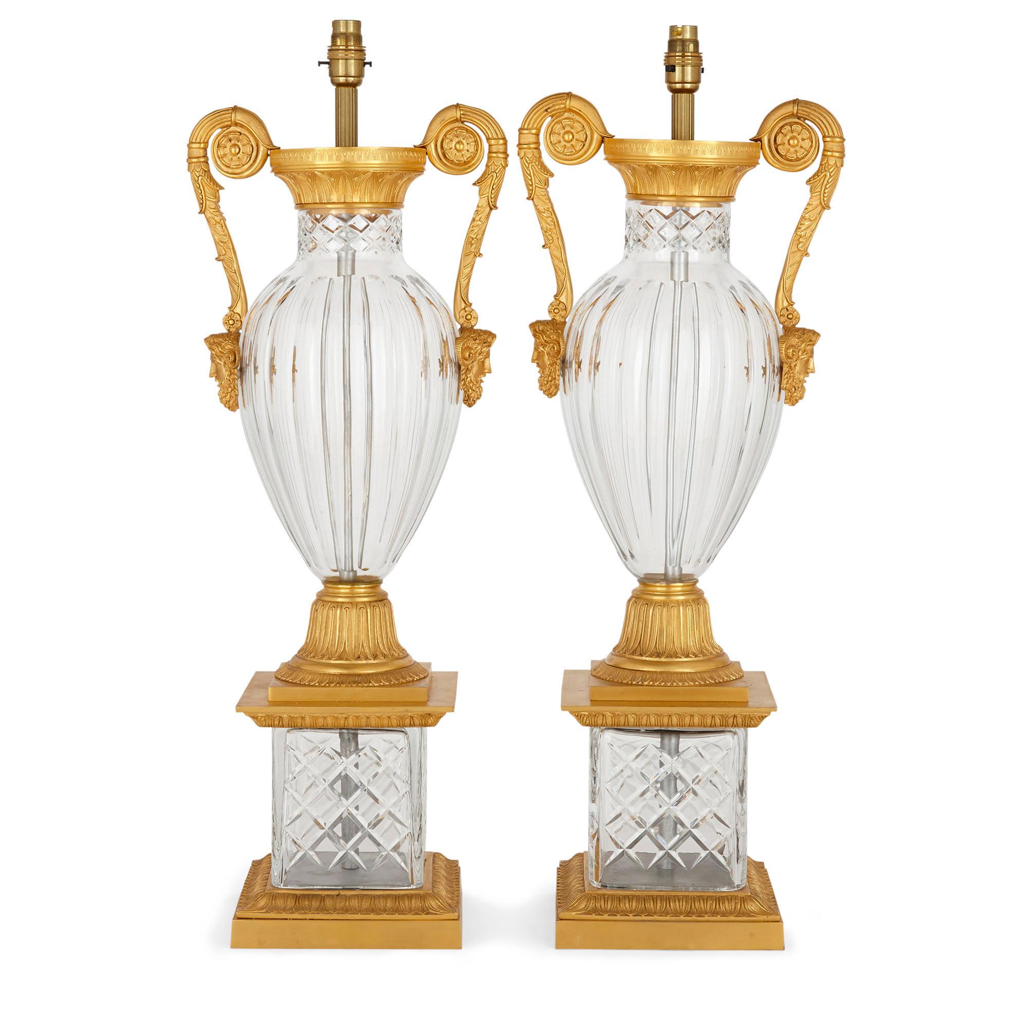 Pair of French neoclassical style gilt bronze and cut glass lamps
French, 20th century
Dimensions: Height 75cm, width 24cm, depth 20cm

Designed in the neoclassical Louis XVI style, this pair of lamps are shaped like vases, and crafted from fine