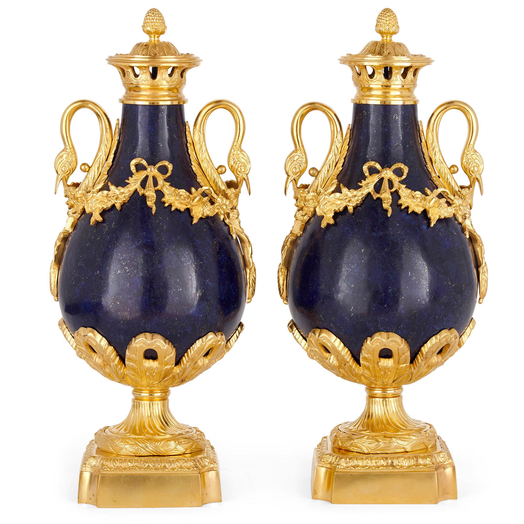Pair of French neoclassical style lapis and gilt bronze vases
French, late 19th century
Measures: Height 46cm, diameter 19cm

Each vase in this pair, crafted from gilt bronze mounted lapis lazuli (the lapis being a later veneer), is baluster