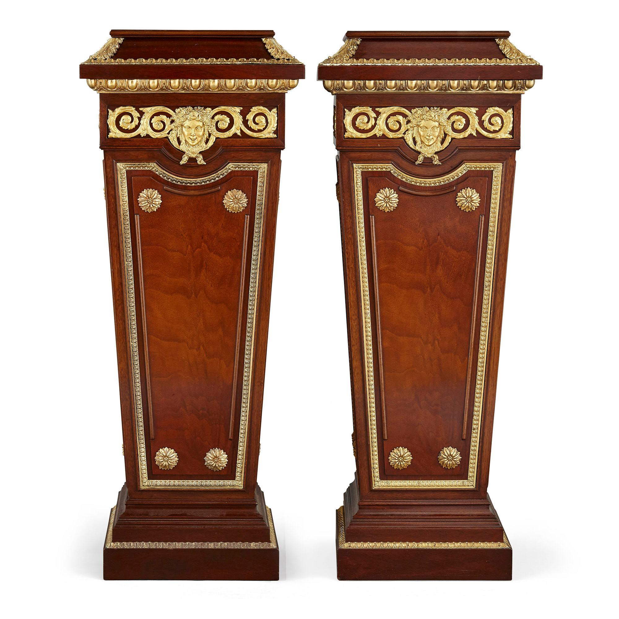 Pair of French neoclassical style parcel gilt mahogany pedestals
French, early 20th century
Measures: Height 104cm, width 41cm, depth 33cm

This fine pair of mahogany pedestals is crafted in the Neoclassical style. Each pedestal is of tapering