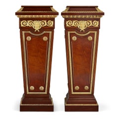 Pair of French Neoclassical Style Parcel Gilt Mahogany Pedestals