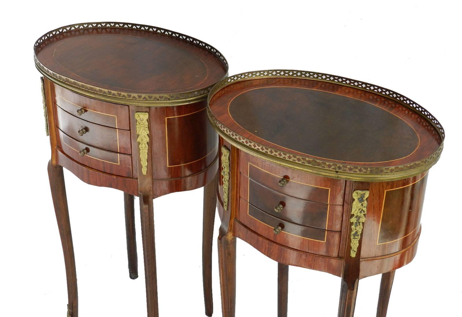 Pair of French nightstands bedside tables Louis revival, circa 1920s
Side cabinets
Unusual oval tops with brass gallery
Each with three small drawers
Ormolu and string inlay
Good vintage condition with minor signs of age and use nothing
