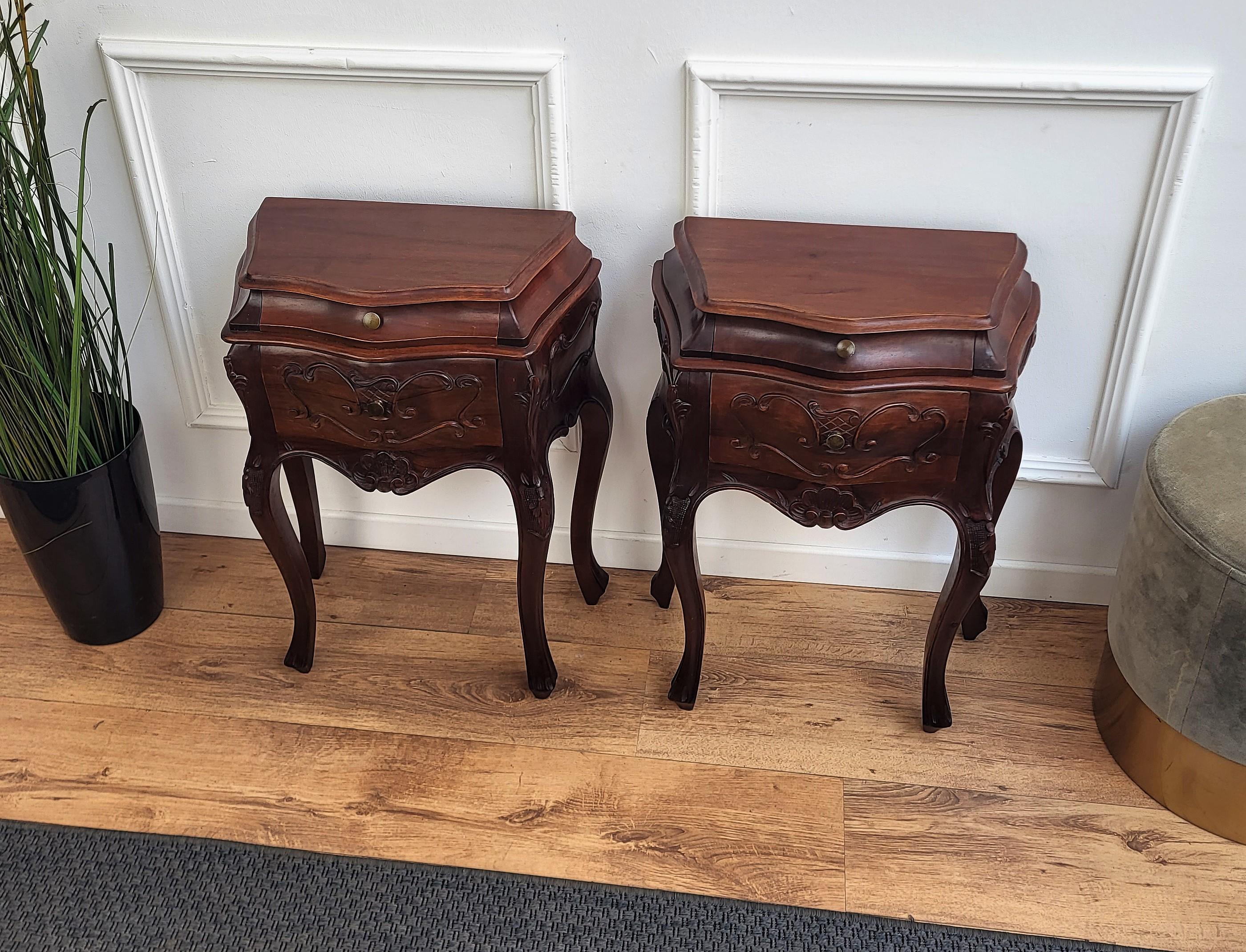 A pair of French carved decorated bedside tables night stands with two drawers.