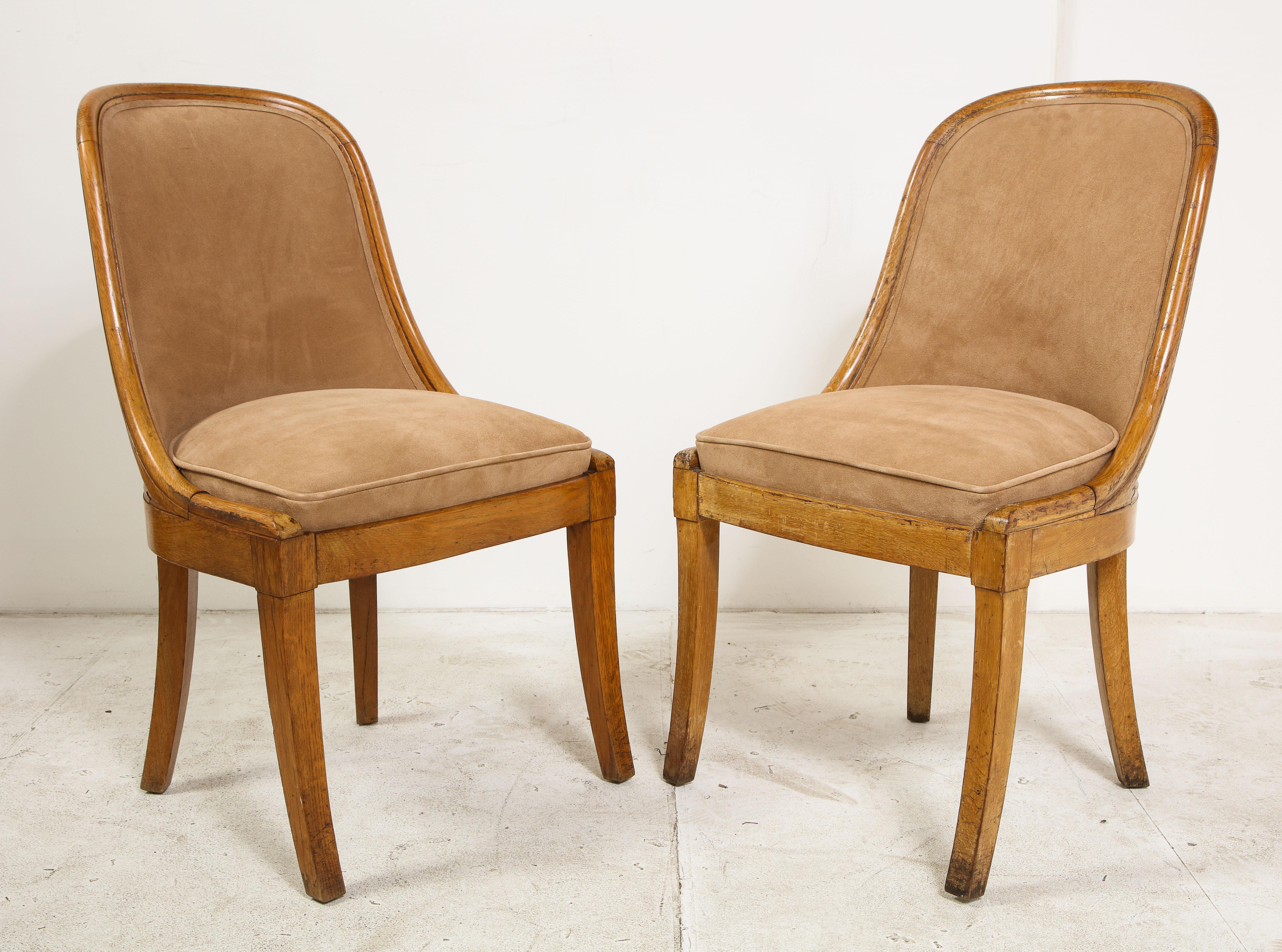 A pair of 1930s French oak side chairs, newly upholstered in tan suede.

           