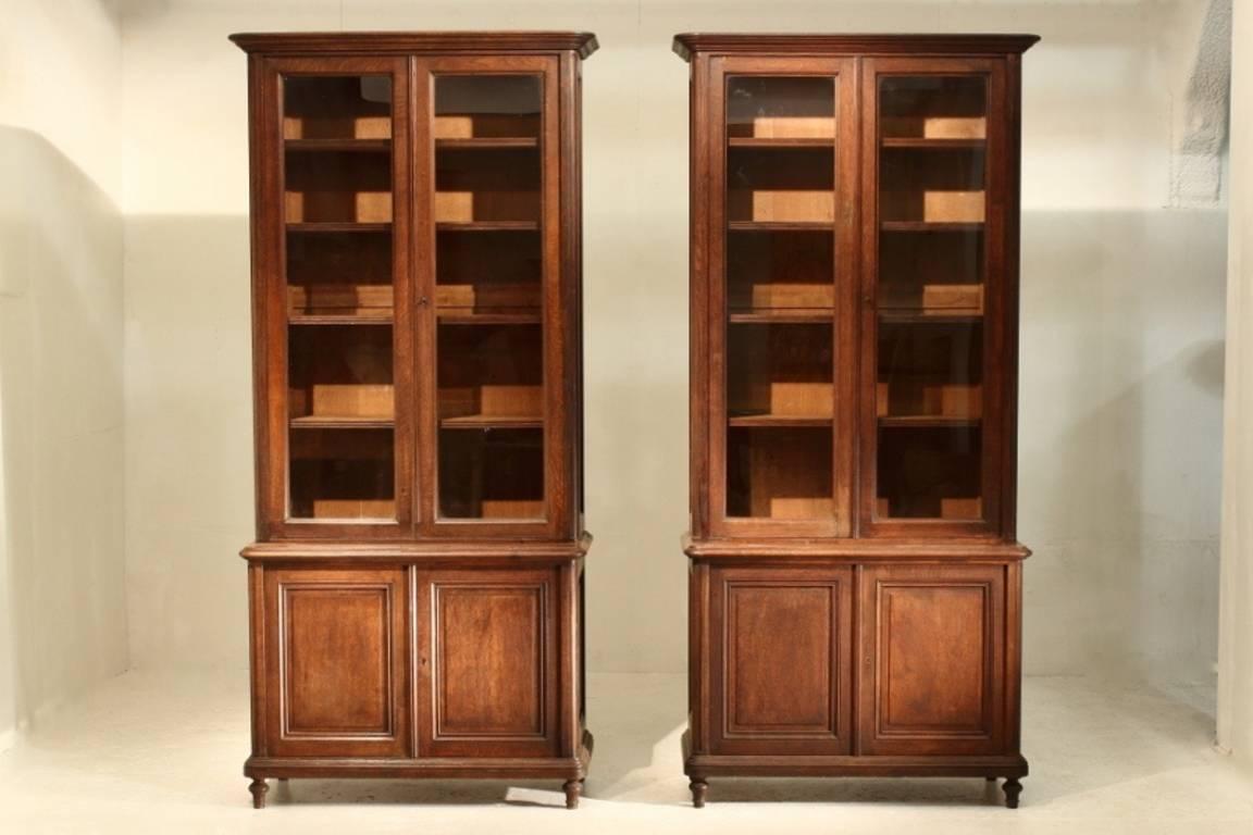 A handsome pair of late 19th century French solid oak bookcases with glazed top sections.

 