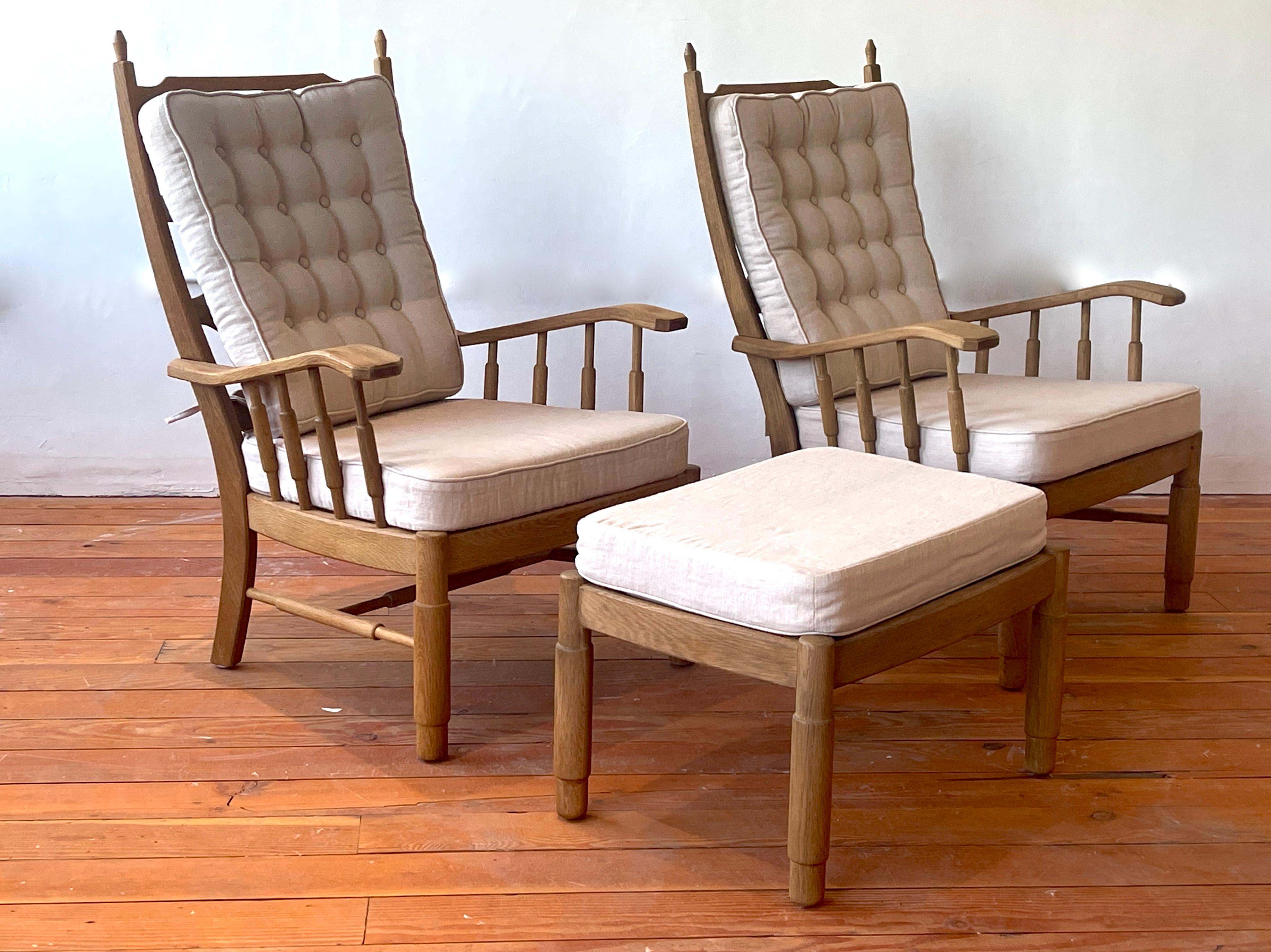 Pair of French oak chairs with spindle sides and ornate horizontal slatted backs. 
Newly upholstered in french beige linen with matching ottoman. 
Great patina to oak.