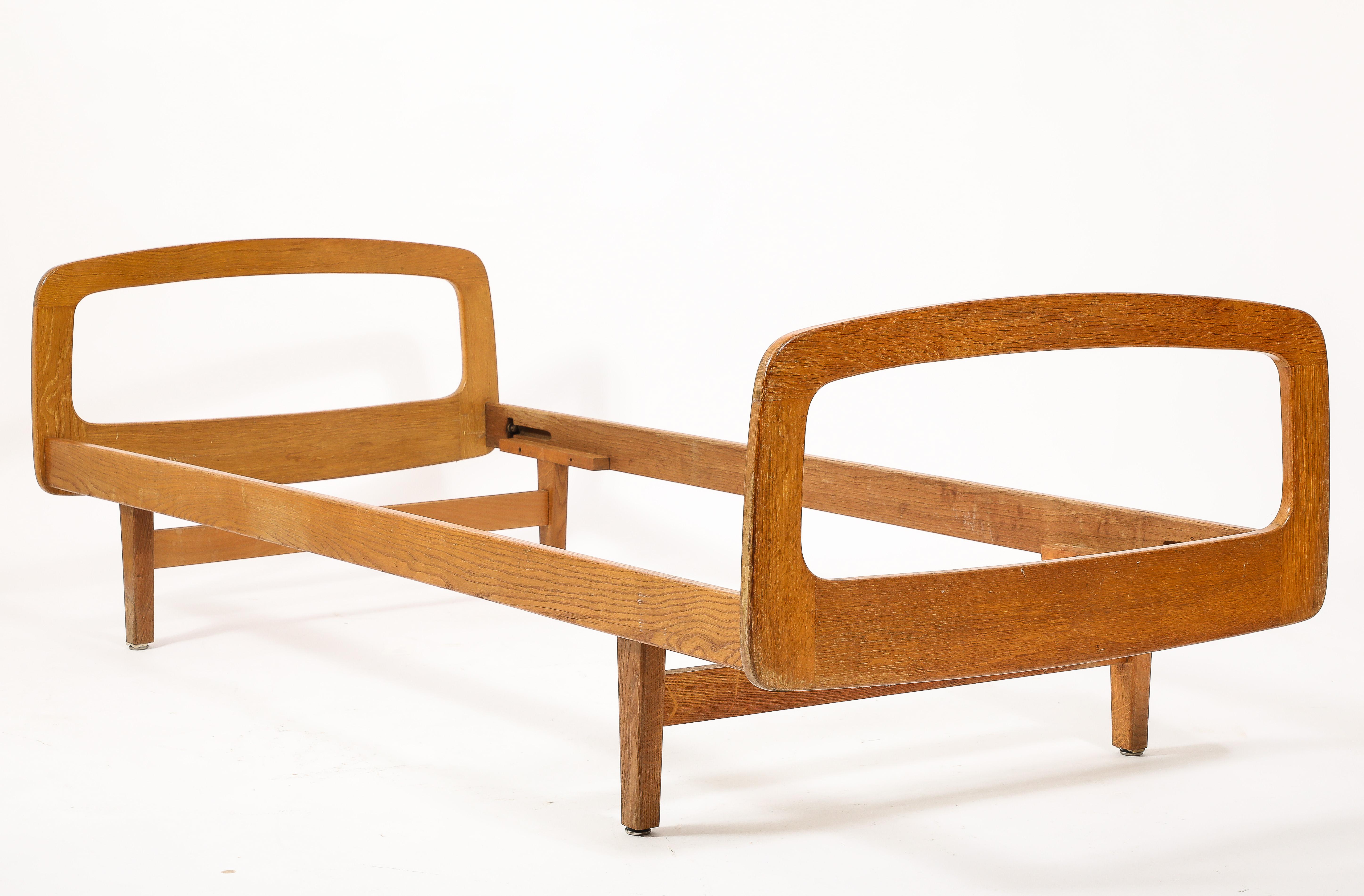 Pair of all oak daybed by Jacques Hauville for BEMA Editions. France 1950's. Unique loop shaped end structures. Minor scratches and dents as shown on pictures.
