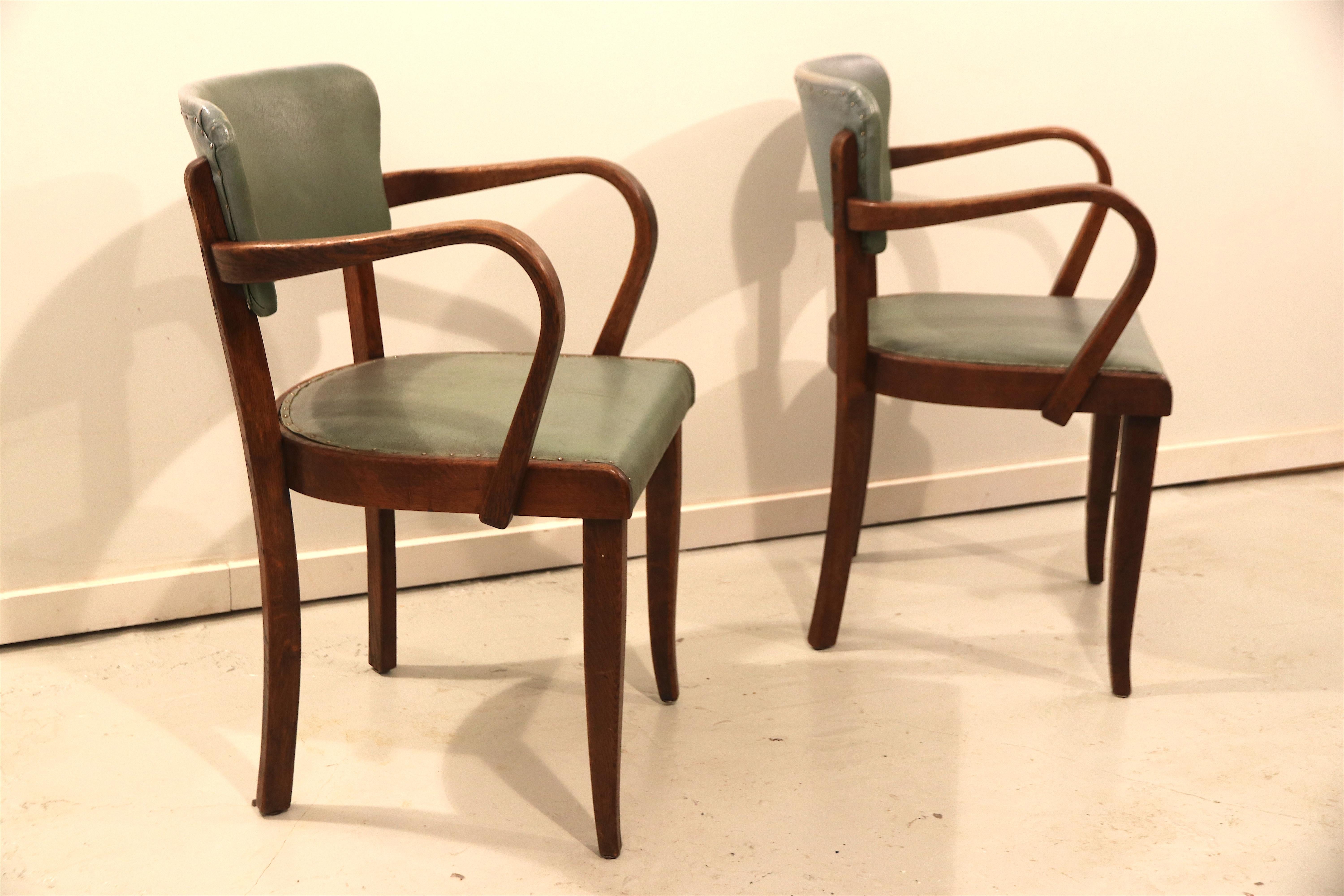 Beautifully shaped art-deco style pair of French oak side chairs, upholstered in their original soft green leatherette; ideal for use in the bedroom or bathroom or as a set of extra dining chairs. The structure has been completely restored and