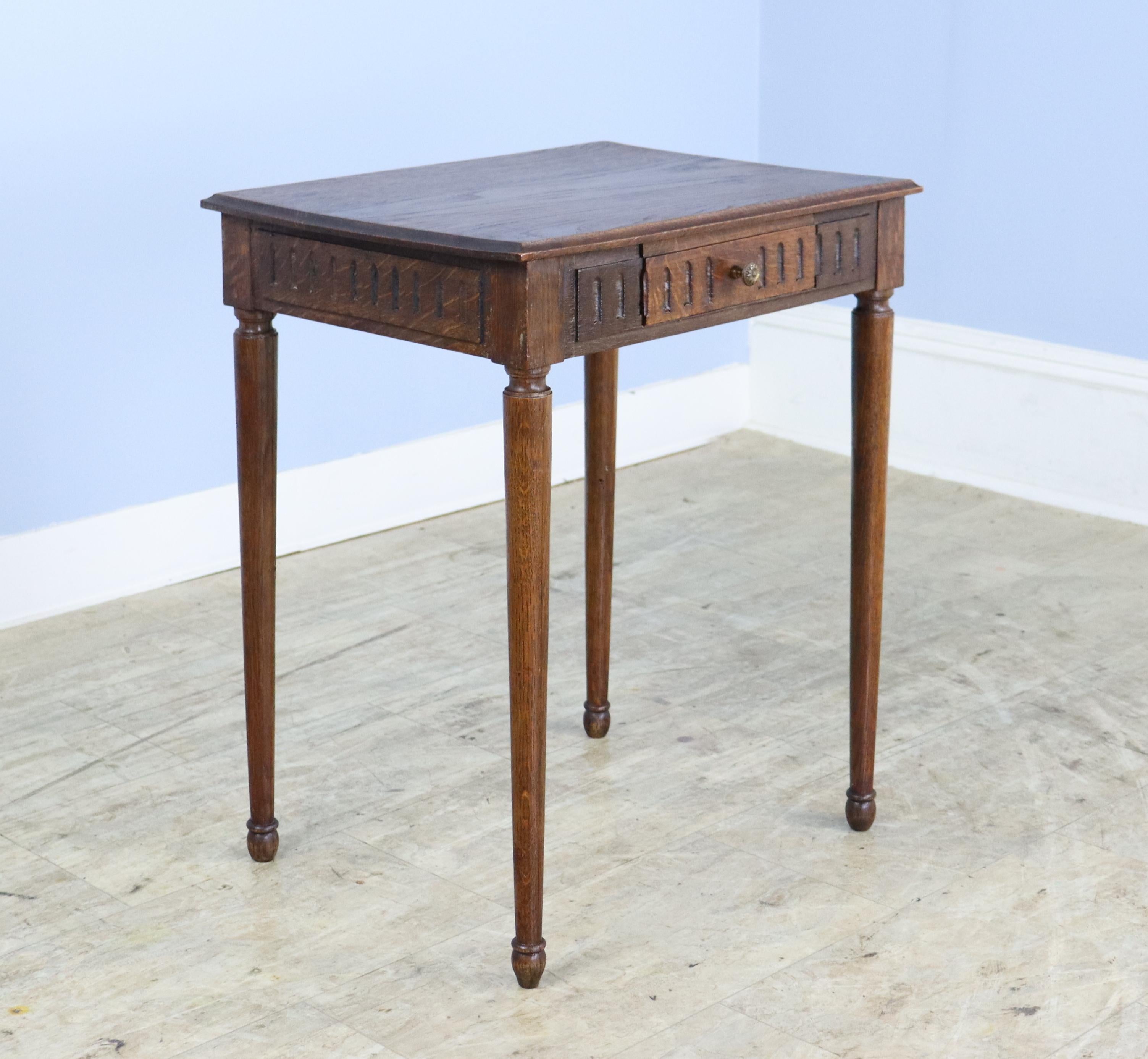 A charming pair of French oak side tables that would make excellent night stands.  The decorative carving goes all the way around the top.  Single roomy drawer and spider legs.  There is a small crack toward the back of one of the pair, which has
