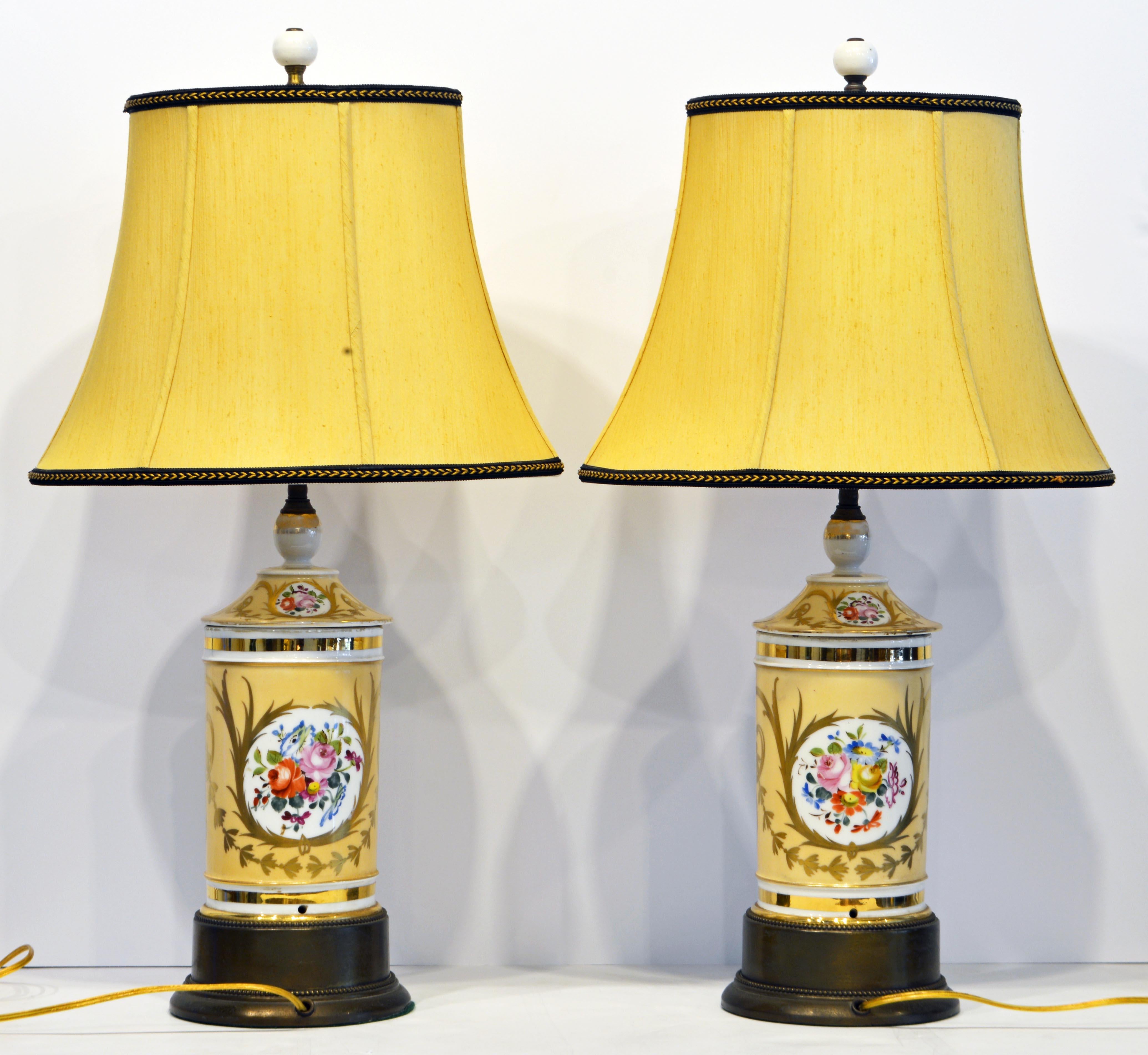 A fine pair of French 'Old Paris' porcelain apothecary Jars with nice slight wear proving their age, late 19th century. They are mounted on later patinated bronze bases to add extra height. The lamp shades are well chosen matching the yellow base of