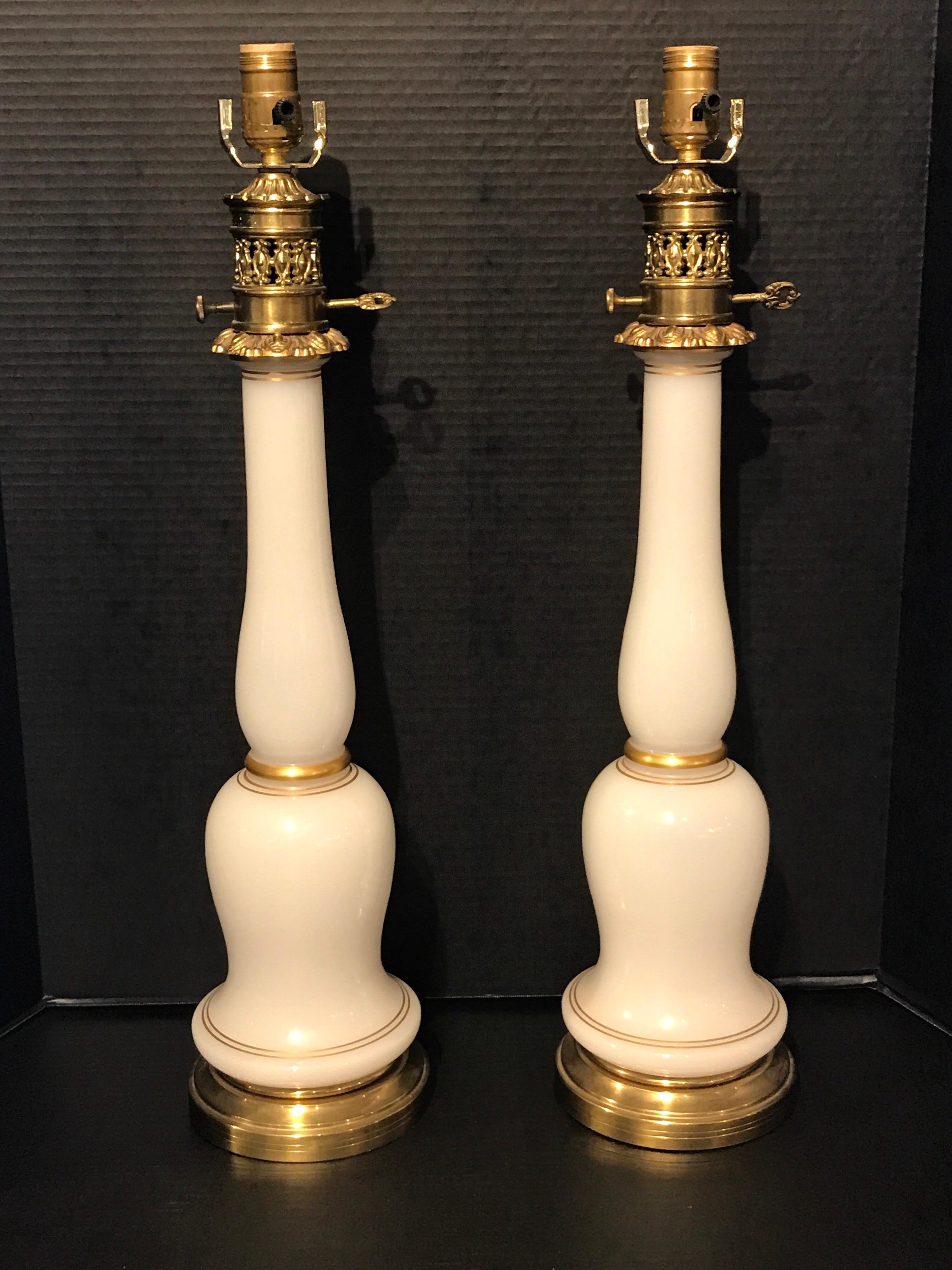 Pair of French opaline bronze column lamps, each one with bronze mounts with gilt highlights. Each lamp stands 26.5