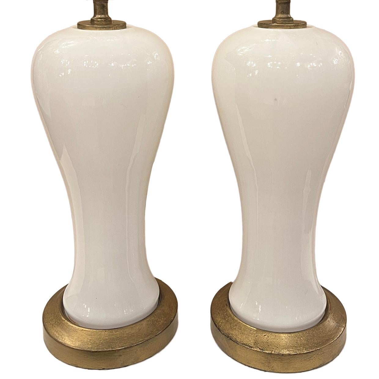 A pair of 1960's French opaline table lamps with gilt bases.

Measurements:
Height of body: 17.5