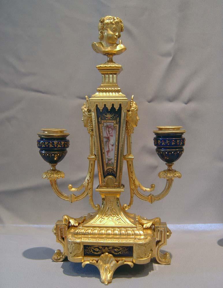 A fine pair of antique French porcelain and fire gilded ormolu candelabra. Superb quality ormolu and very finely hand painted Bleu du Roi jewelled Paris porcelain. The candleholders are of jewelled bleu du roi porcelain and every piece is in perfect
