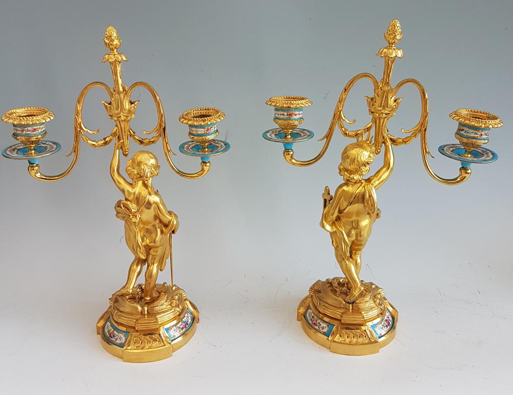 A fine pair of antique French porcelain and fire gilded ormolu candelabra. Superb quality ormolu and very finely hand painted celeste porcelain. The candle holders are of celeste porcelain and every piece is in perfect unrestored condition. This is