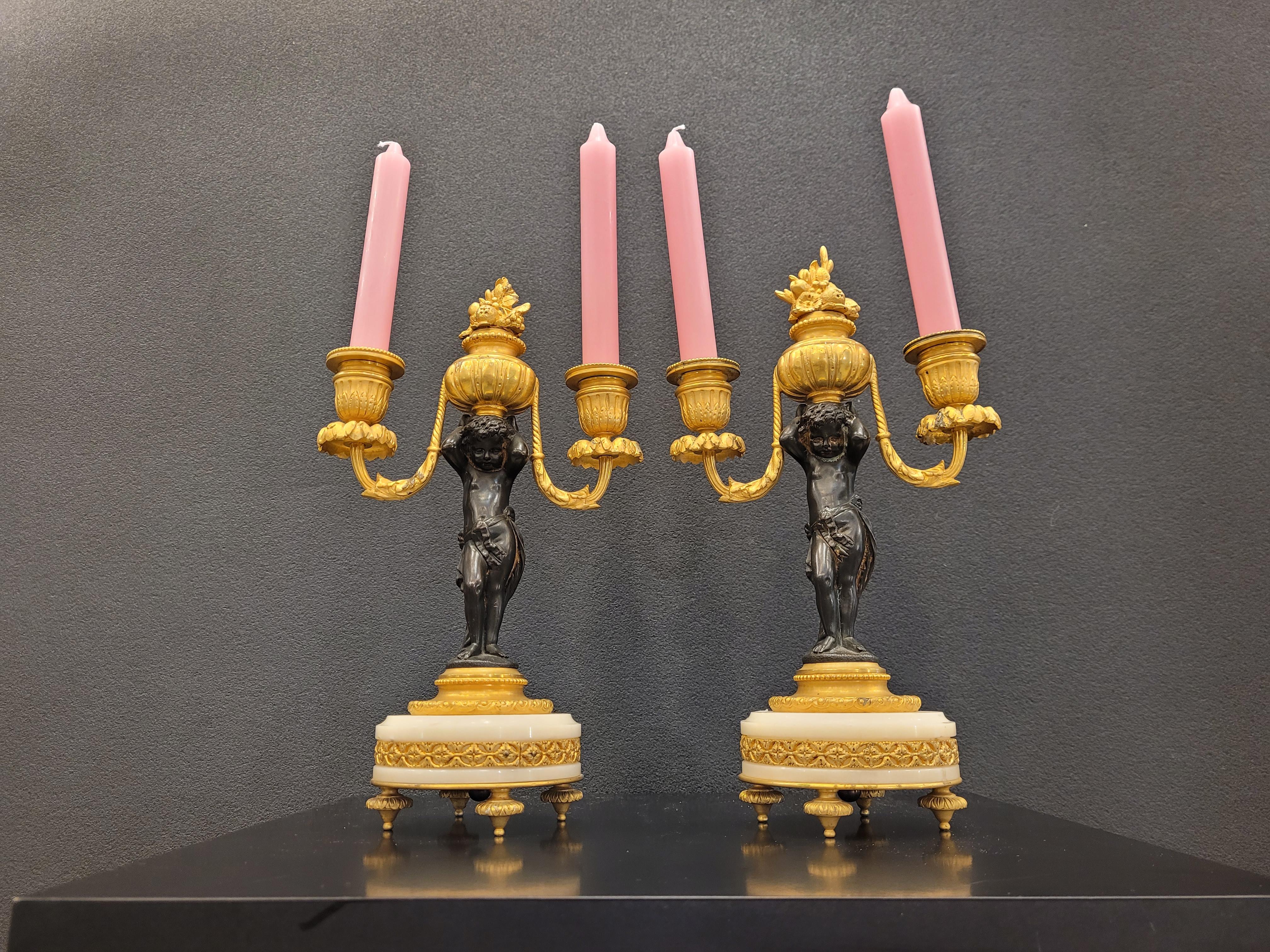Hand-Crafted Pair of  French Ormolu  marble bronze candlesticks gilt bronze putti For Sale