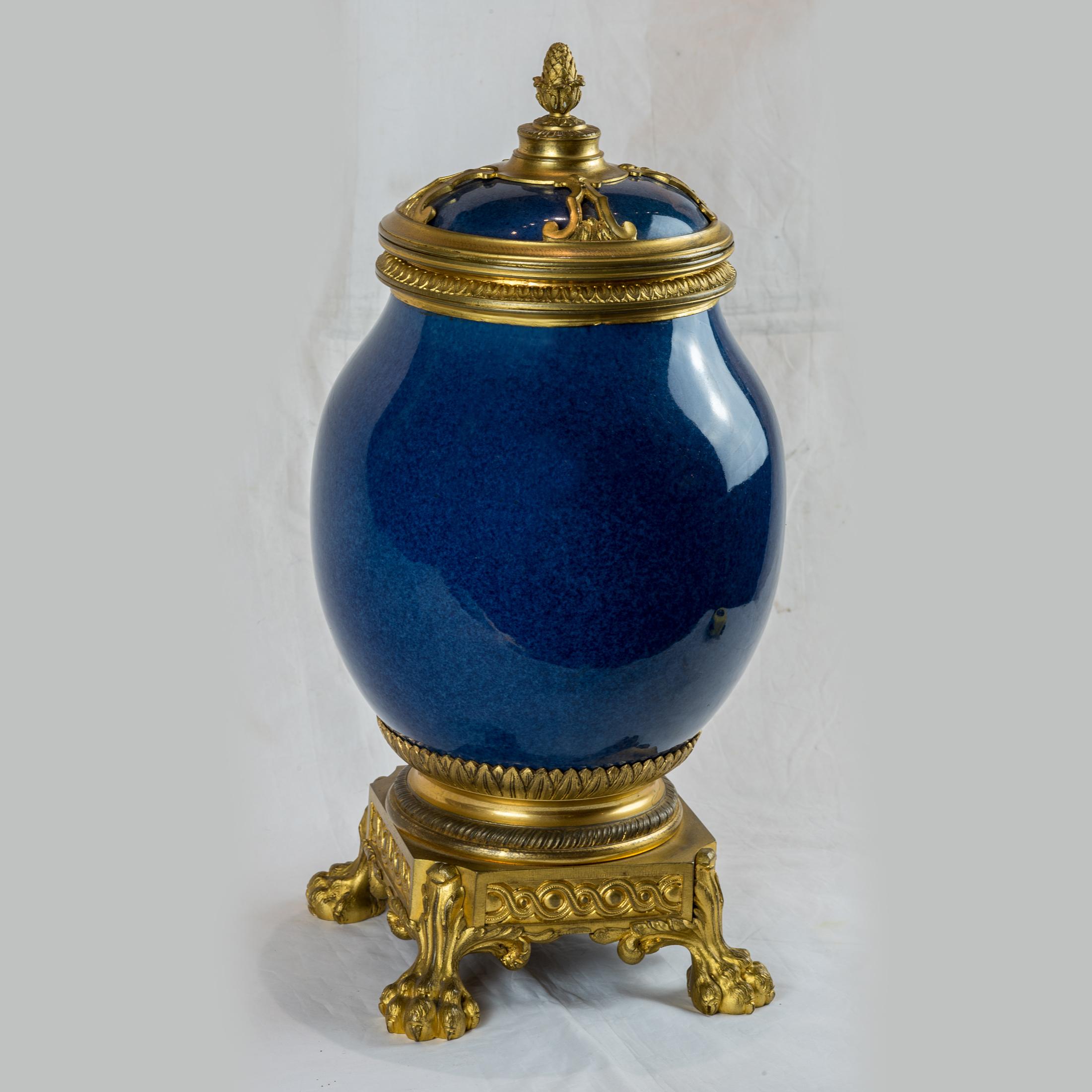 A fine quality pair of French Ormolu-Mounted Chinese Porcelain Vases and Covers in mottled blue-ground glaze. Resting on square ormolu base with paw feet.

Origin: French
Date: late 19th century
Size: 20.5 x 8 1/2 inches