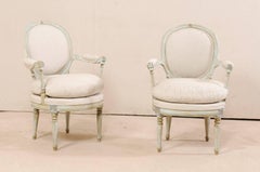 Pair of French Oval-Back Bergère Chairs with Delicately Carved Floral Motifs