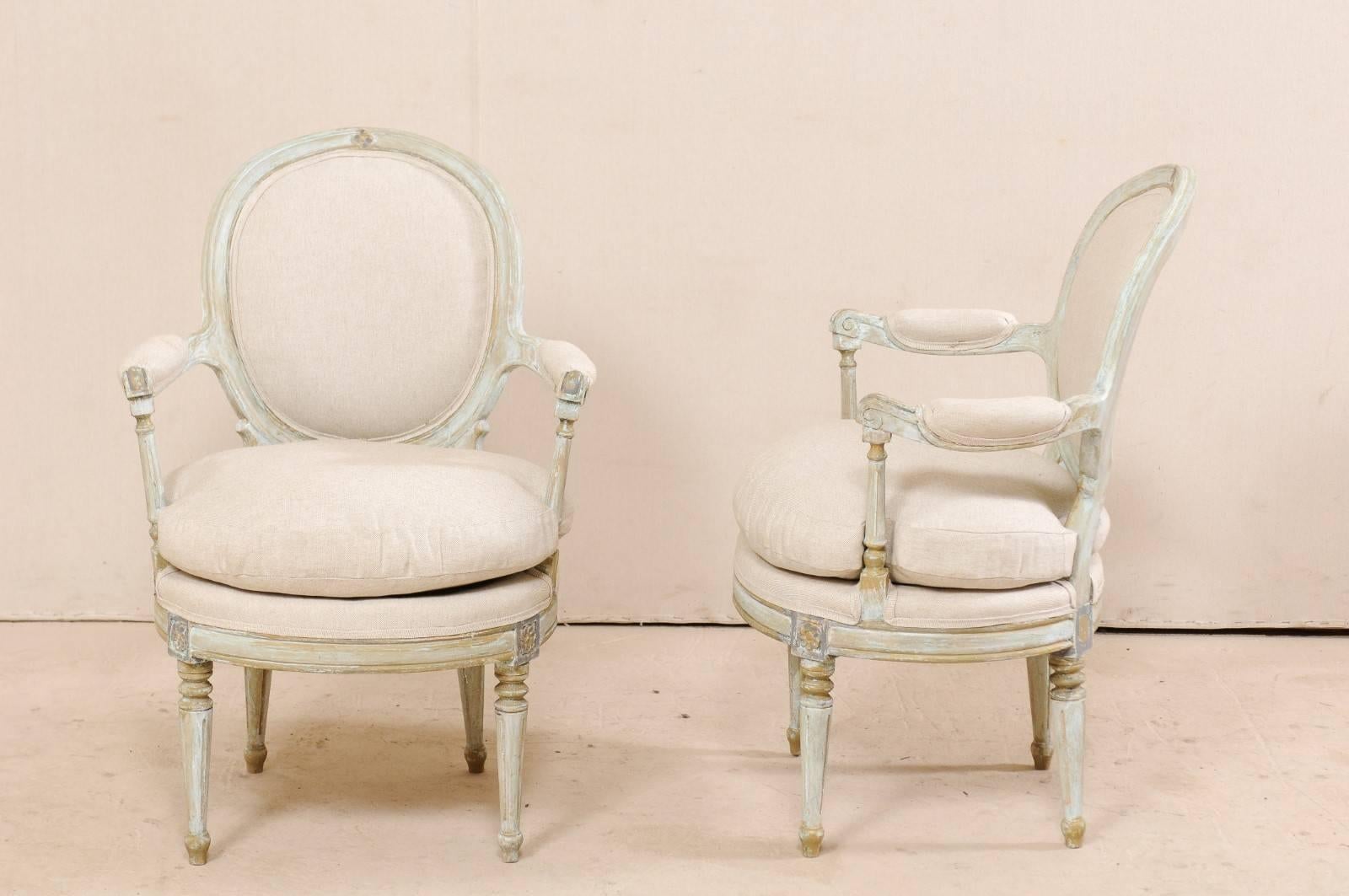 Wood Pair of French Oval-Back Bergère Chairs with Delicately Carved Floral Motifs