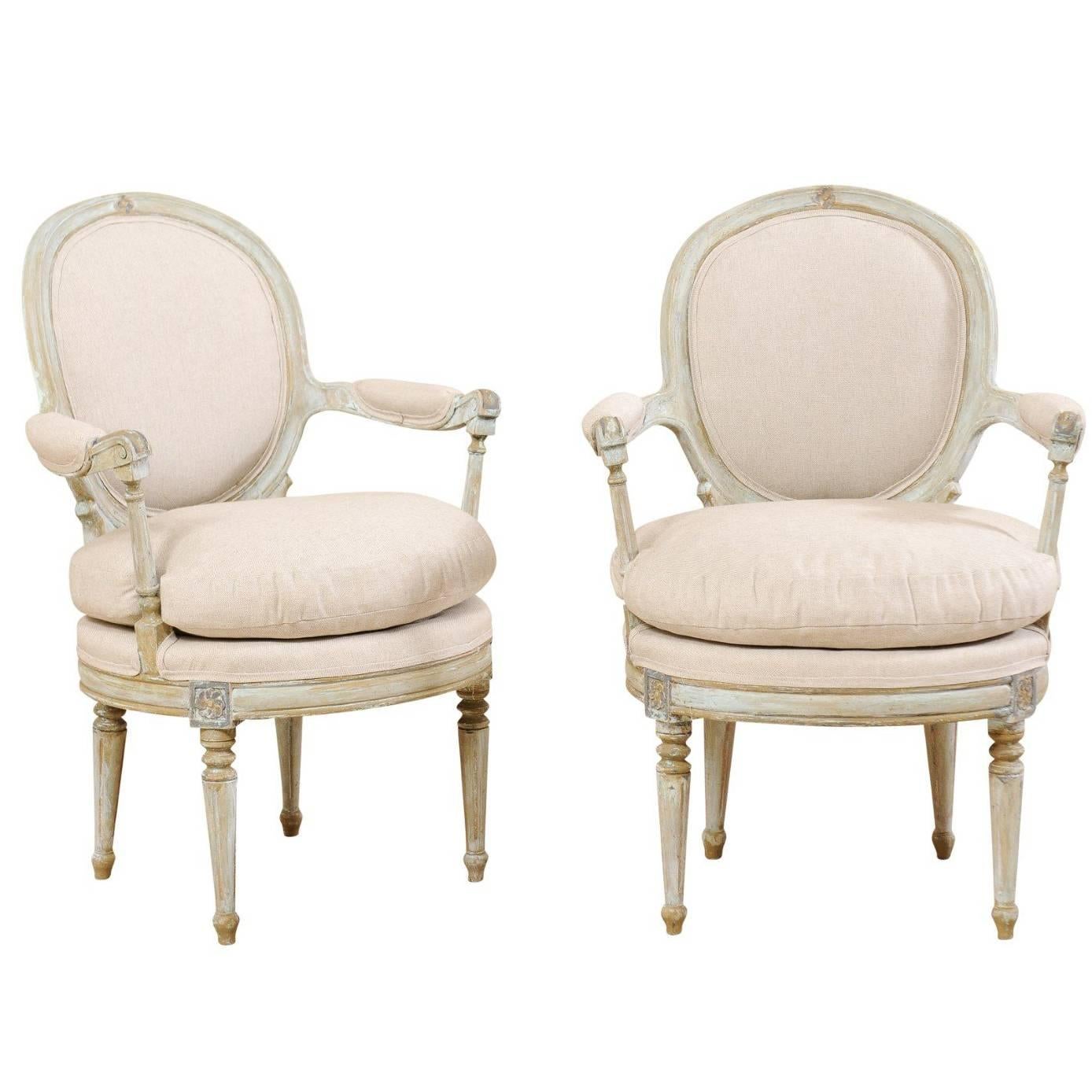 Pair of French Oval-Back Bergère Chairs with Delicately Carved Floral Motifs