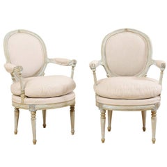 Pair of French Oval-Back Bergère Chairs with Delicately Carved Floral Motifs