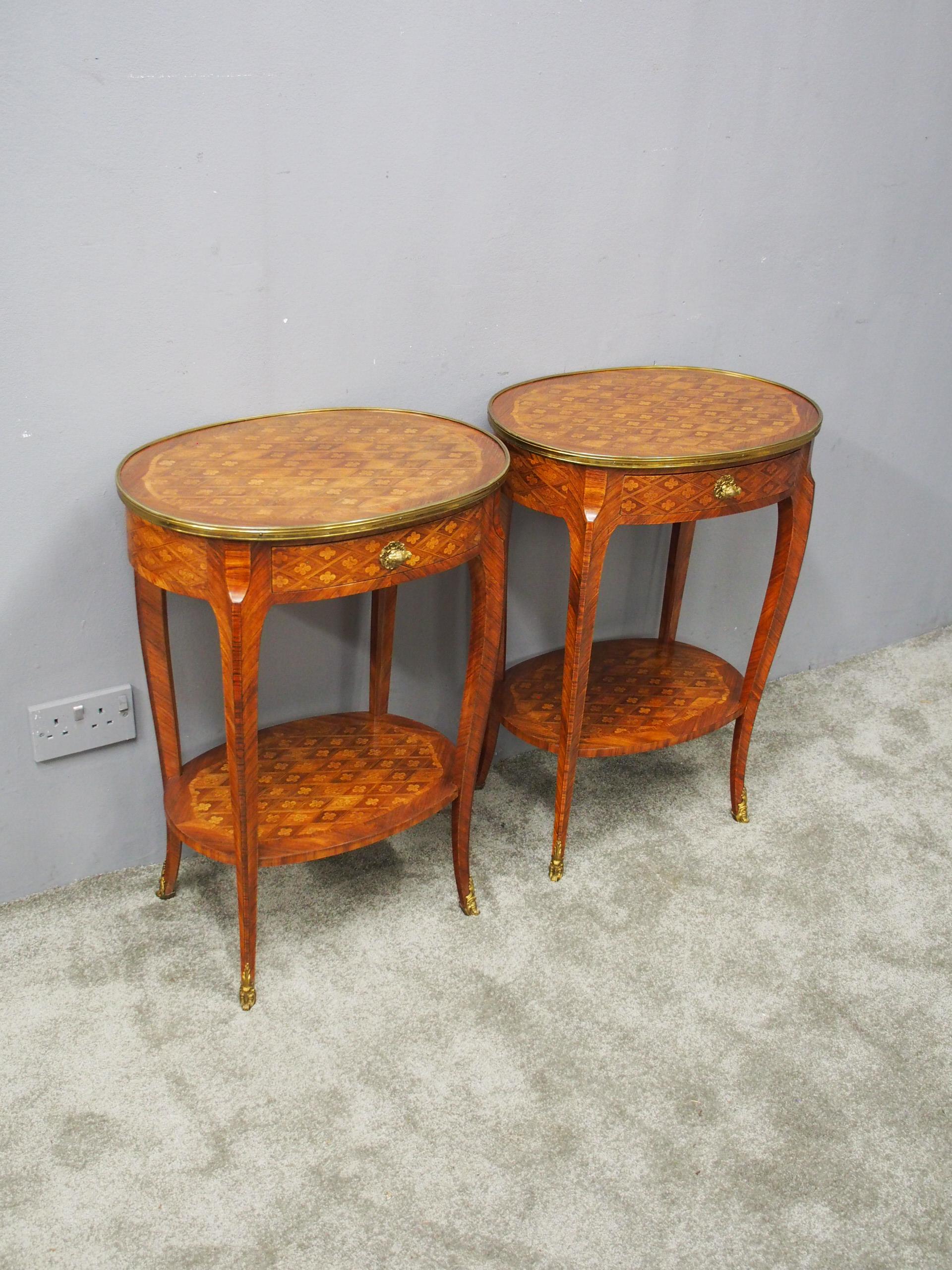 Pair of French oval marquetry and parquetry kingwood occasional tables, circa 1880. The oval shaped tables have a shaped brass band with a crossbanding of parquetry, and inlaid top panel. Beneath the top is one bow fronted drawer with similar inlay