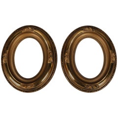 Pair of French Oval Scroll and Foliate Giltwood Art Frames, 20th Century