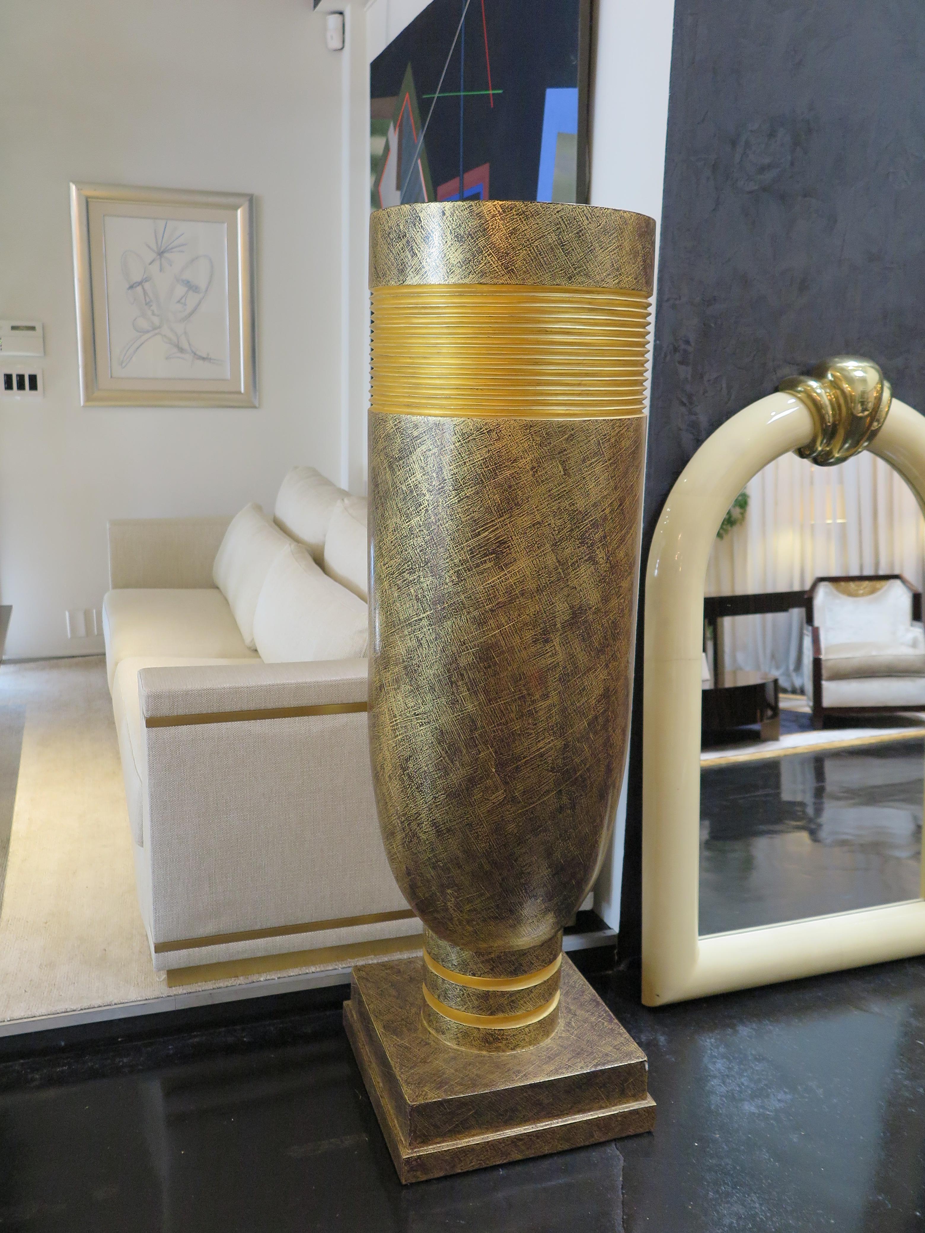 These extra large vases/decorative urns feature plaster basins with a golden patina finish with black accents. Originally created as oversized torchieres, they can be repurposed as stunning vases with plant or flower arrangements. Impressively large