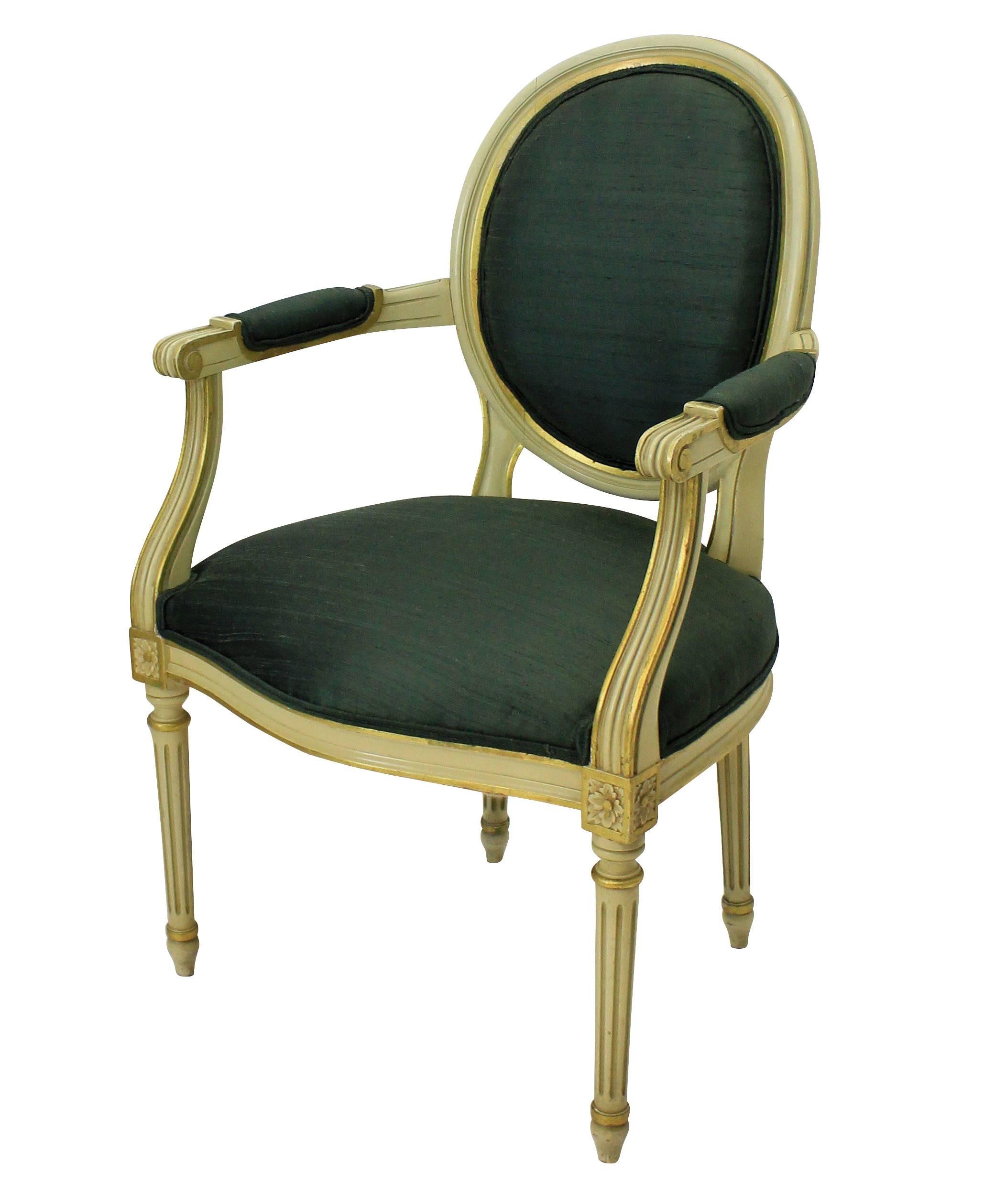 A pair of French painted and gilded Louis XV style armchairs upholstered in sage green silk.
 