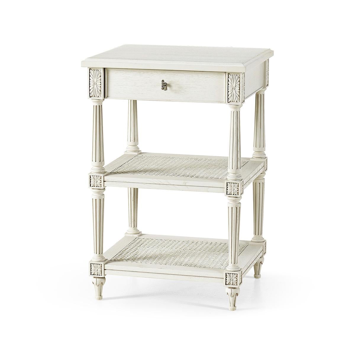 French Painted Nightstand, white painted one drawer bedside tables with floral carvings and a grey painted finish. Two cane shelves add a touch of modernism with turned and fluted supports.

Dimensions: 20