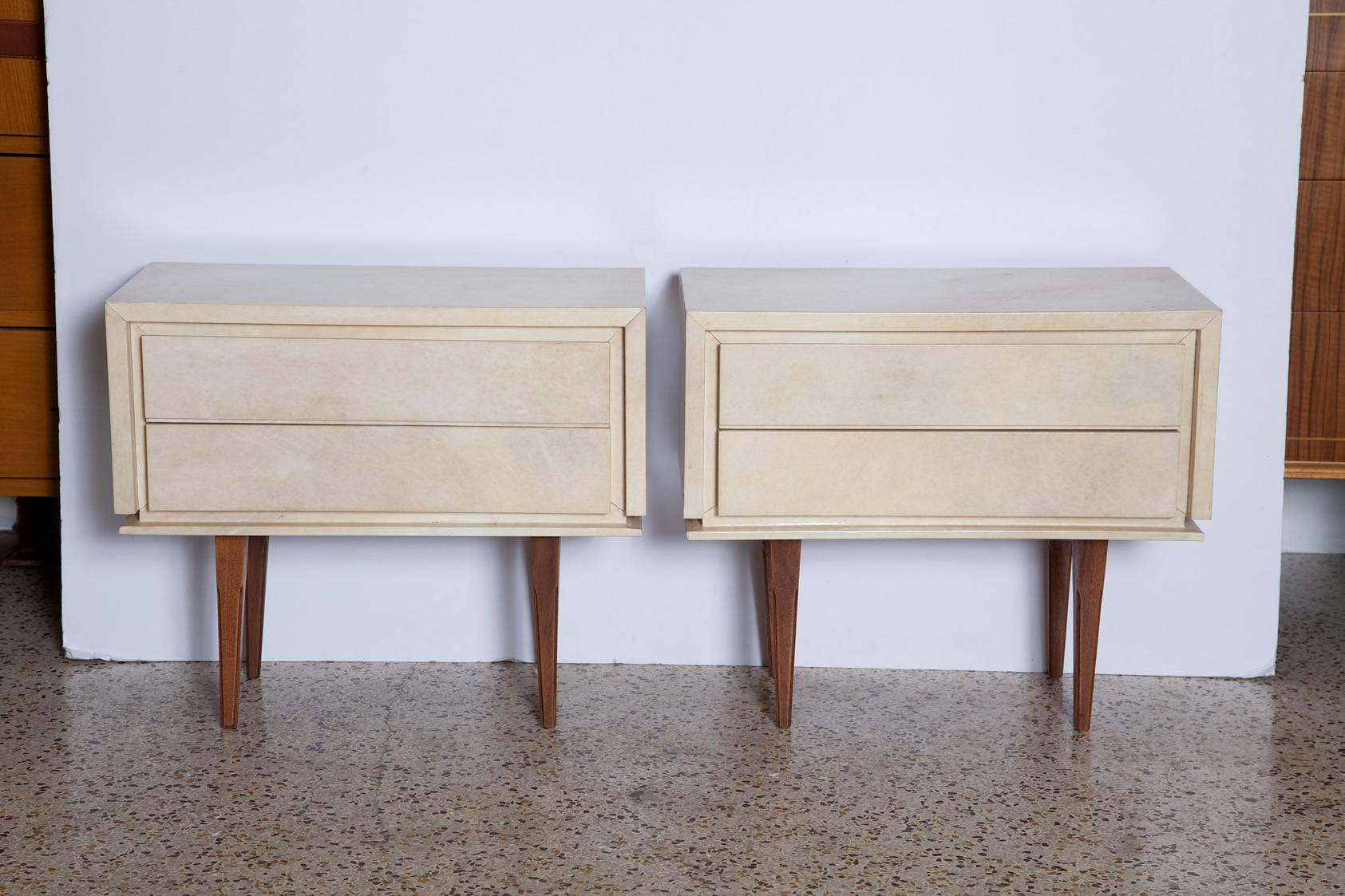 Diminutive pair of 1960s French parchment covered nightstands in subtle shades of cream and palest grey atop simply carved solid mahogany legs.