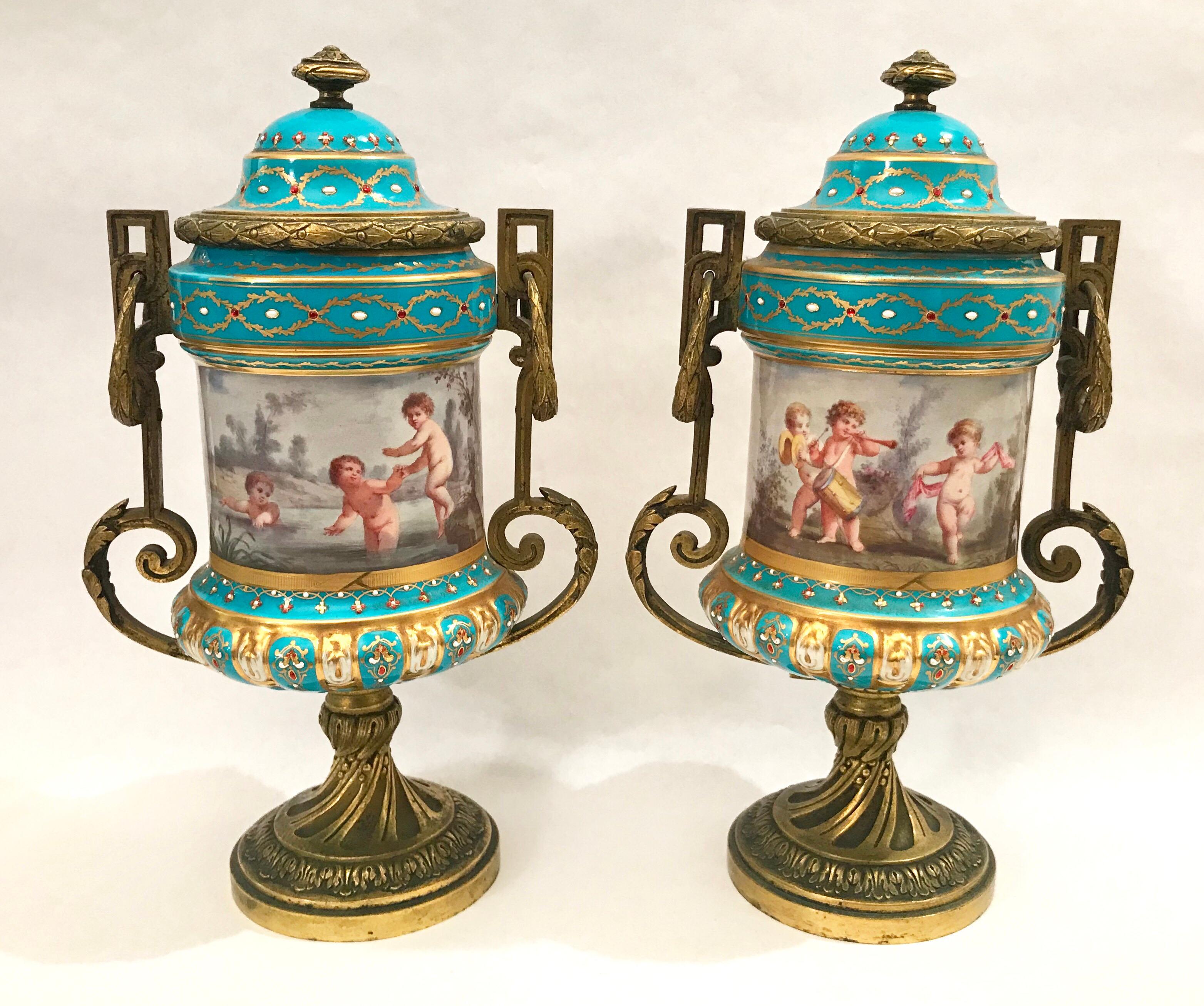 Pair of French hand painted gilt bronze mounted porcelain urns, France, 19th century.