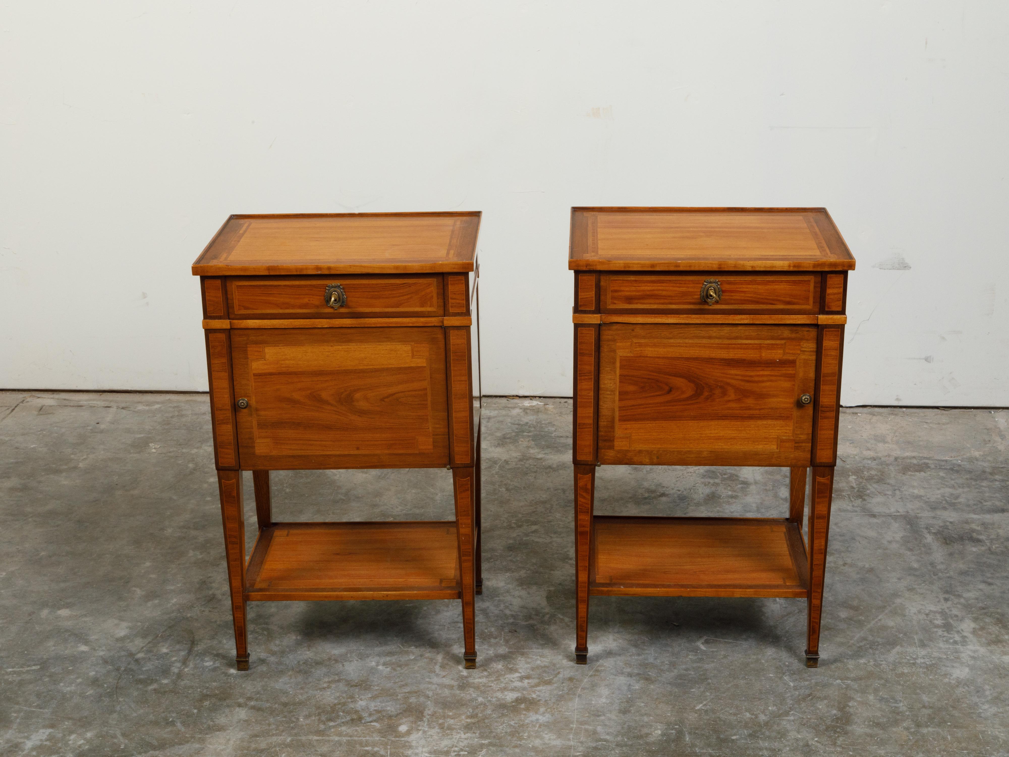 A pair of French Paul Sormani walnut bedside tables from the late 19th century, with banding. Created in France at the end of the 19th century, each of this pair of nightstands features a rectangular top with inlay, sitting above a single drawer