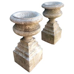 Pair of French "Pierre de Cassis" Tazza Urns on Integrated Plinths