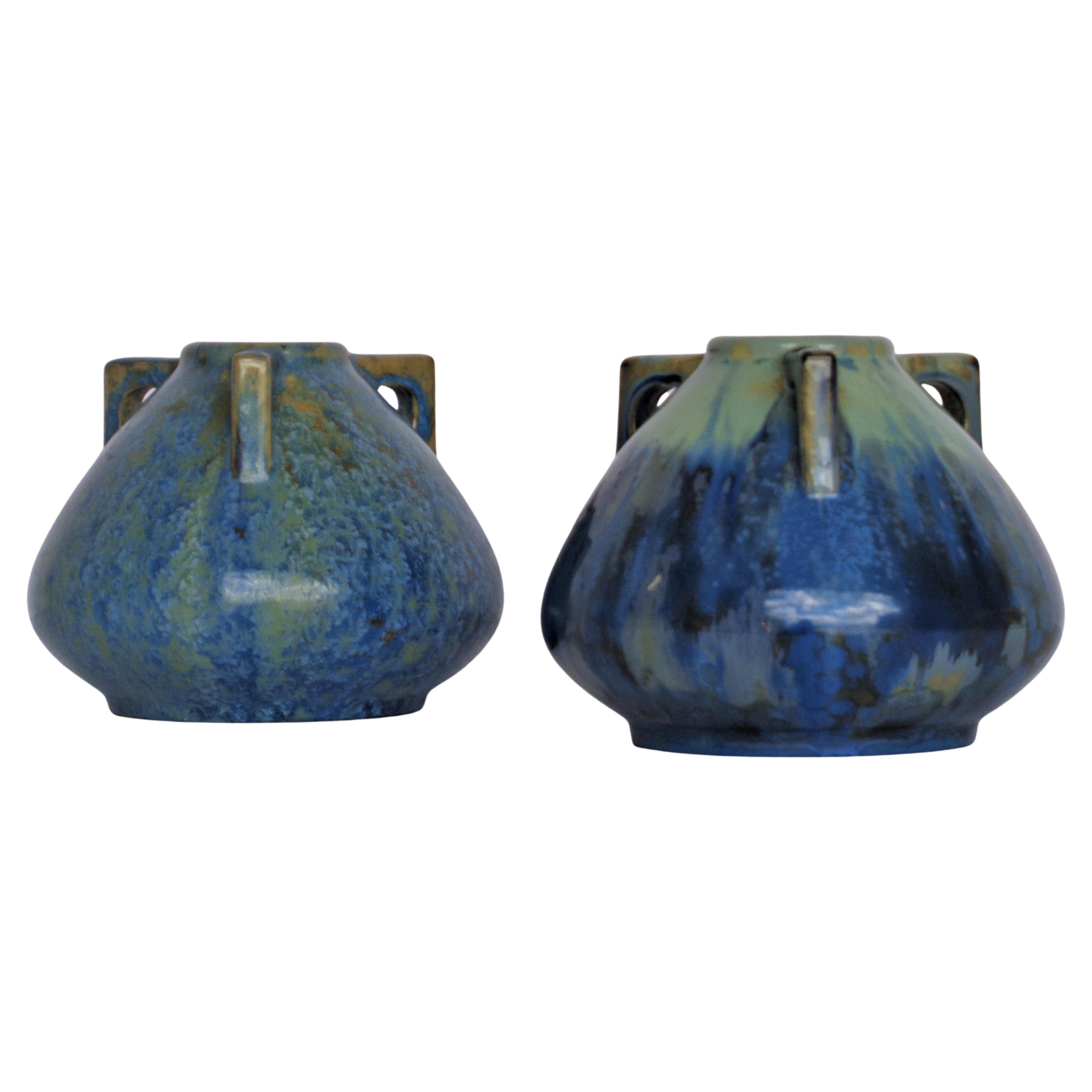 Pair of Pierrefonds ( La Faiencerie Heraldique de Pierrefonds ) stoneware ceramic pottery buttressed handled vases in different blue flambe and crystalline glazes. Stamped signed on underside. Transitional Arts and Crafts - Art Deco period design.