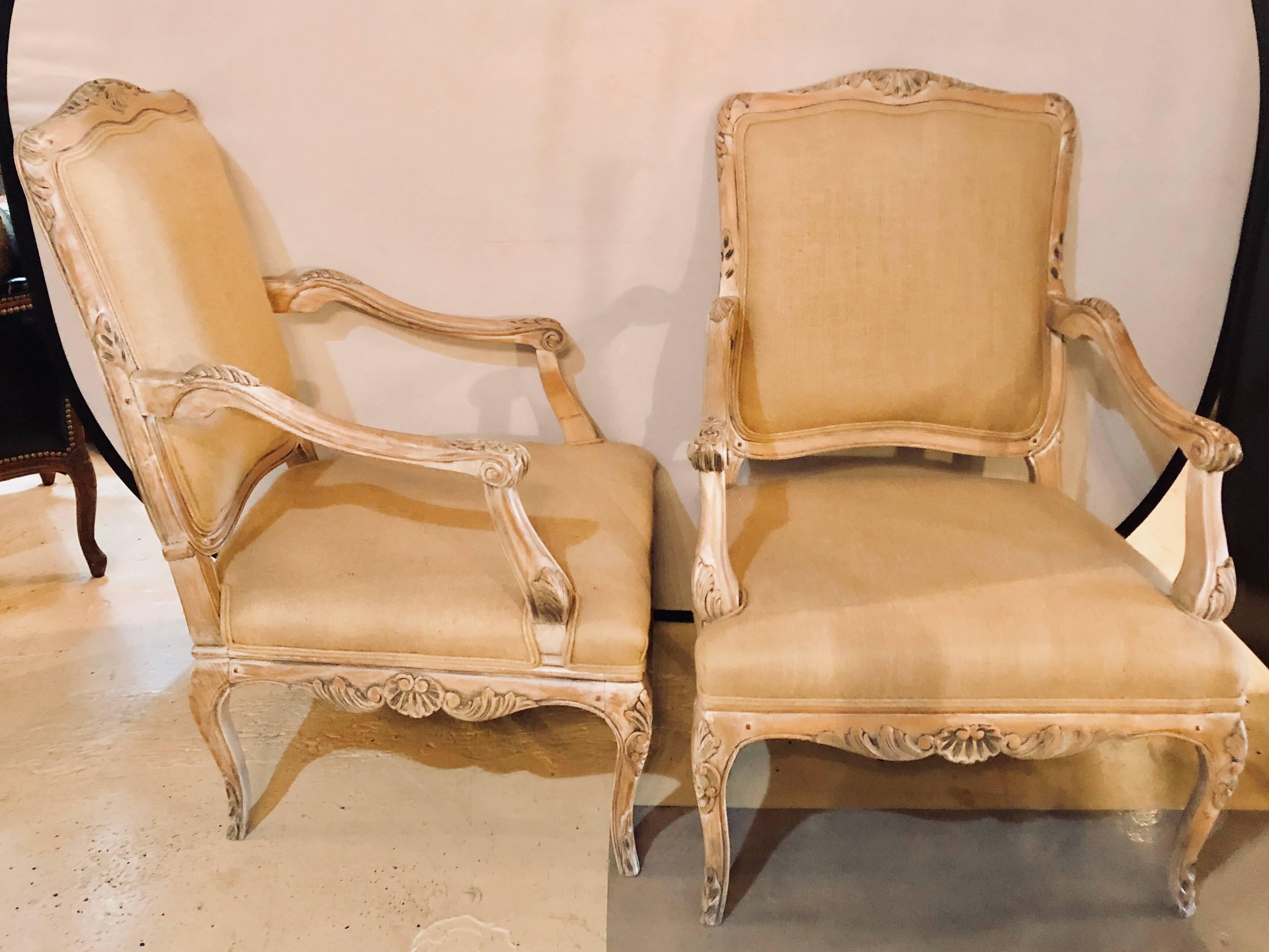 A pair of French pin construction burlap armchairs or fauteuil chairs. This fine pair of chairs have a washed distressed finish with new burlap upholstery. Each frame having pin construction.
