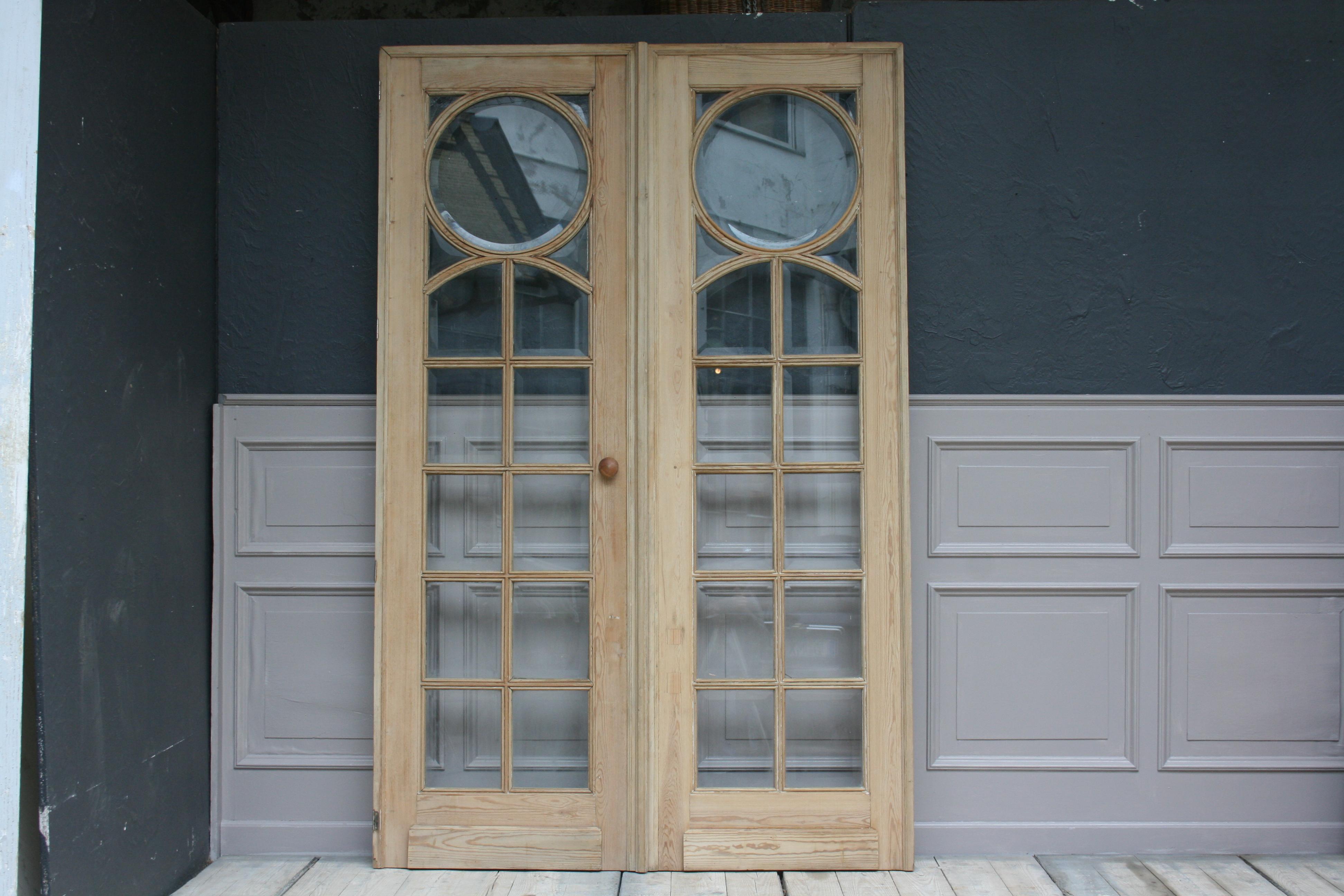 Beautiful French Art Deco double door, circa from the 1920s, made of bleached pine wood made with beveled cut glass.
The doors are without lock.

Dimensions: 
220 cm high / 86.61 inch high,
72/ 142 cm wide / 28,34/ 55.9 inch wide,
5.5 cm deep