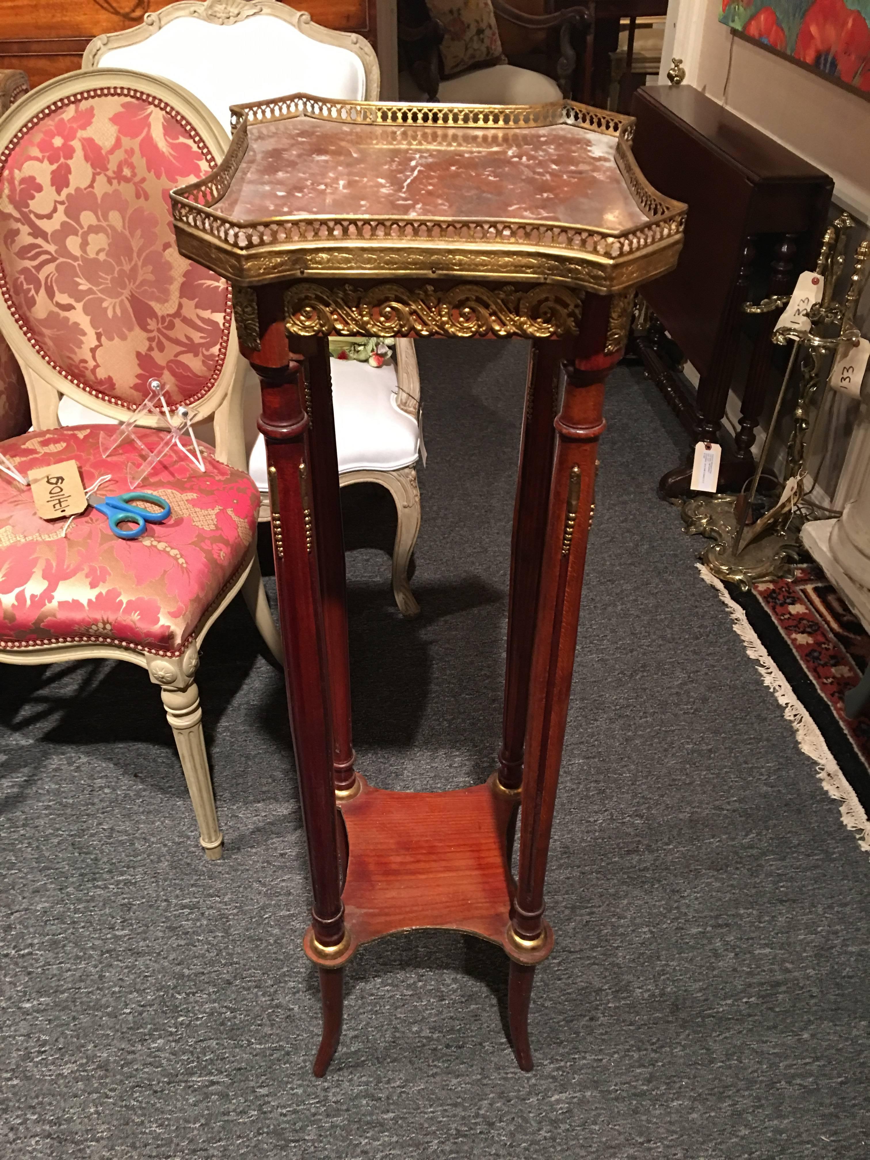 Pair of French plant stands or pedestals with marble tops and brass decoration, 19th century.