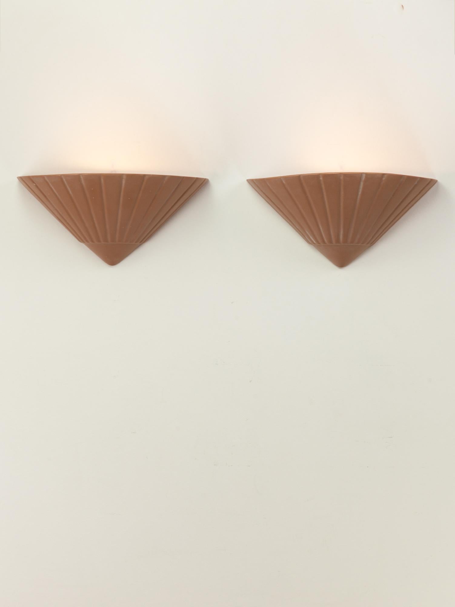 A pair of painted French plaster wall lights in a pinkish terracotta colour. The conical shape has a patterned surface.  Made in France. 1970s.

Great vintage condition with some signs of wear. Newly wired. Sourced from France.

Height 15.5 cm  5.9
