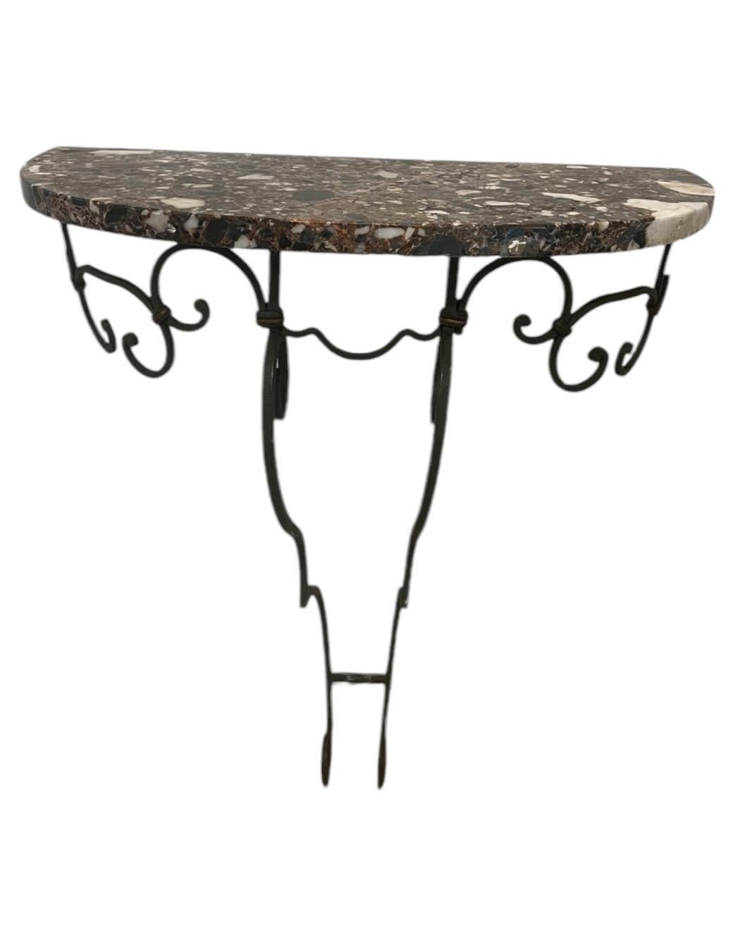 Rare Matching Pair of marble top half moon demilune console tables.  Wall Mount iron base.  
Elegant scroll base with curvilinear apron.  Warm toned marble top.  
Overall great used condition.   

Must be attached to the wall for stability.  Great